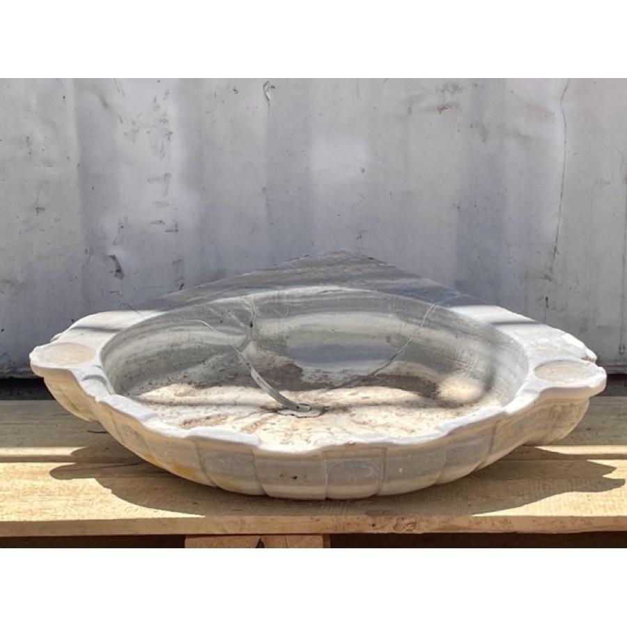 A lovely, antique corner sink of French marble. Its shell motif gives the impression that it was plucked from the sea floor. There is a thoughtfully placed alcove at each corner for soap, lotion or other accoutrements.

Beautiful texture and