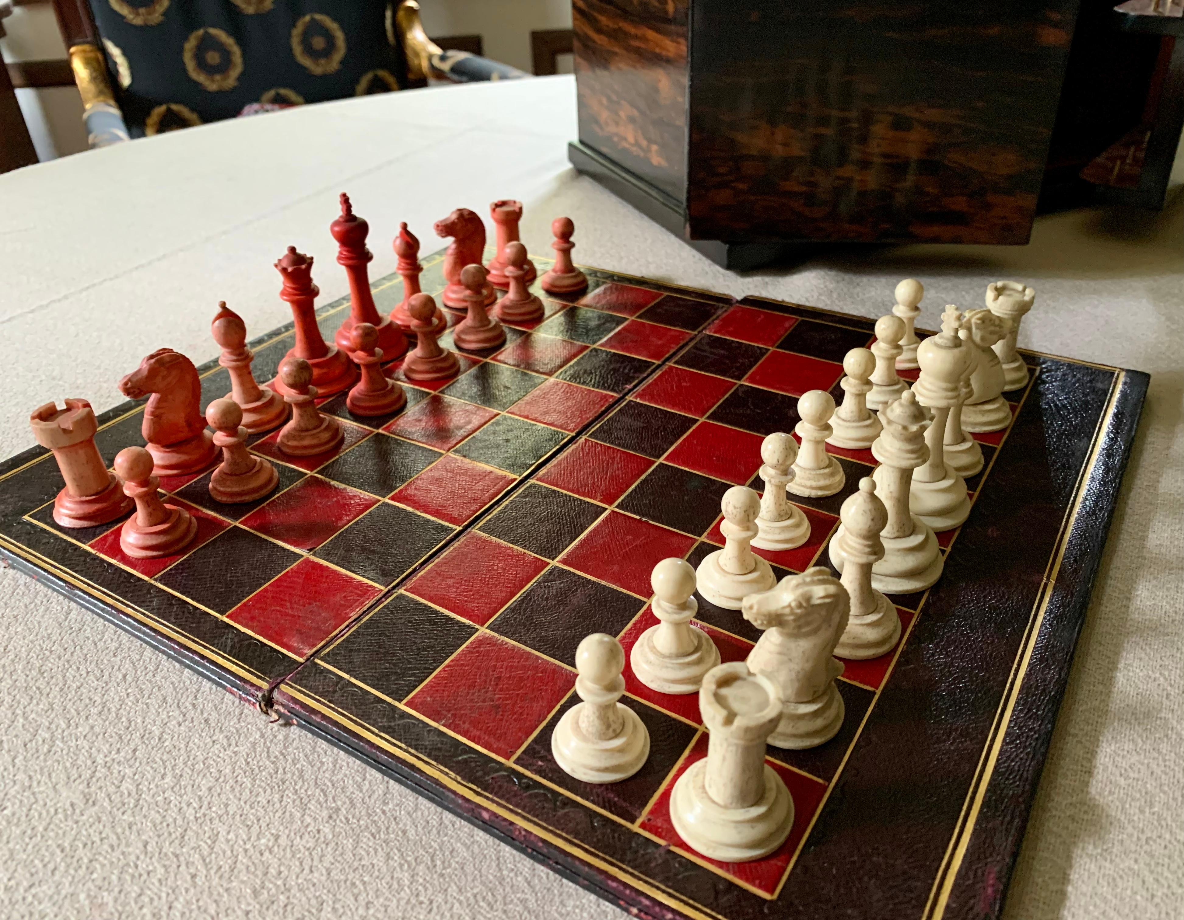 One of the finest game boxes we've had the pleasure of offering, classic Regency Style, the case beautifully constructed of rare, dramatically figured Coromandel wood, lift top with front panel doors opening to reveal a hand carved chess set of