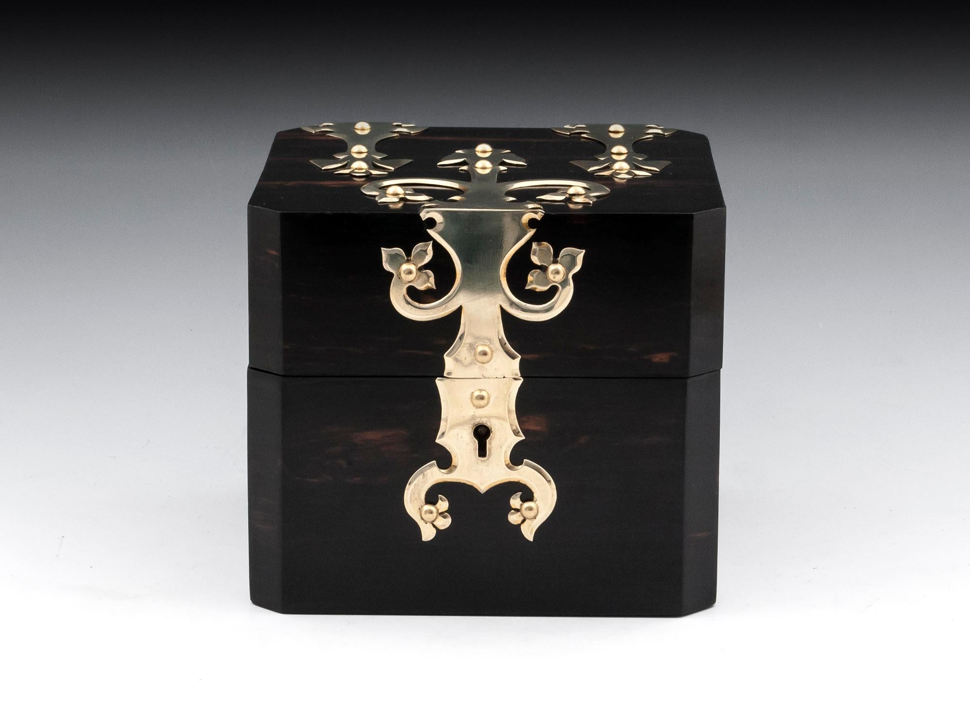 Antique jewelry box with canted corners veneered in exotic coromandel with ornate brass mounts. 

The interior of our bespoke fitted antique watch / jewelry box is lined in a deep green velvet and silk paper. It contains a removable jewelry tray