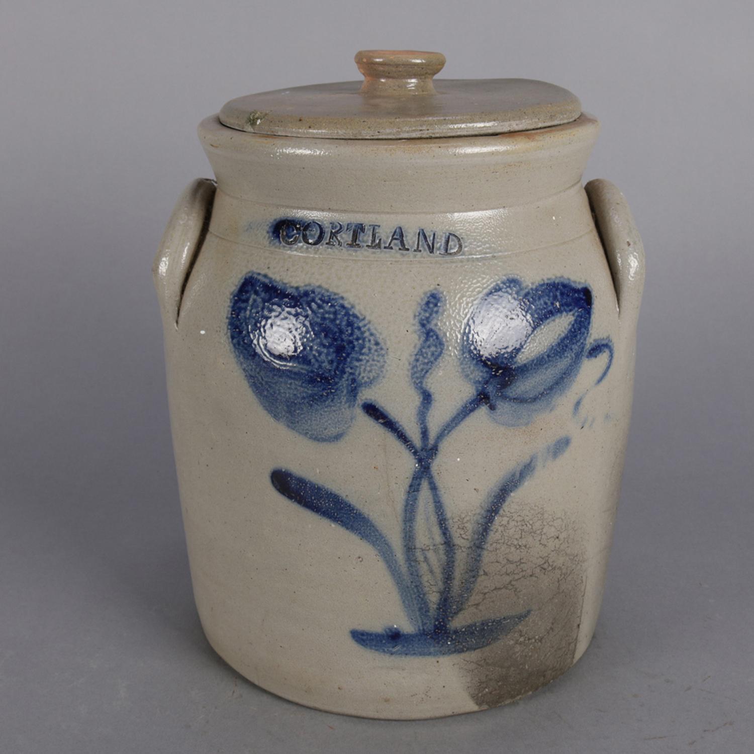 Antique New York double handled and lidded stoneware crock features hand-painted blue decorated tulip design surmounted by Cortland stamp, circa 1860.

Measures: 12