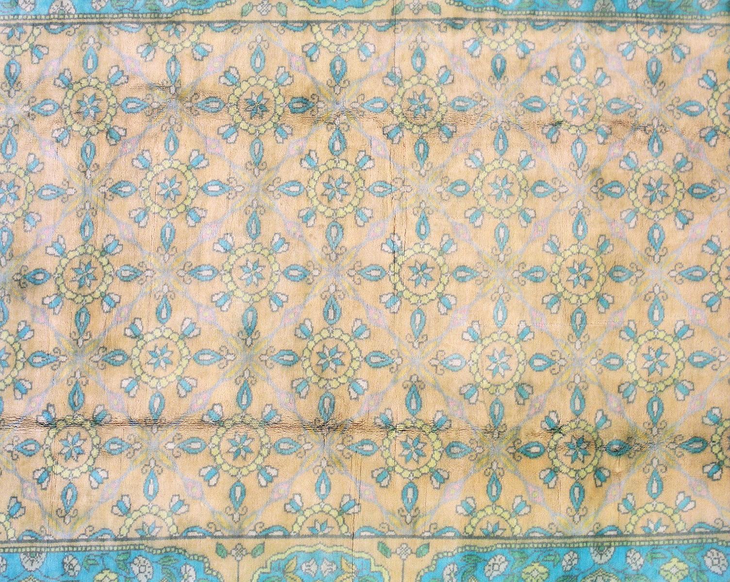 Hand knotted cotton pile on a cotton foundation.

Dimensions: 6' x 9'

Origin: India

Condition: Excellent

Field color: Peach

Border color: Peach

Accent colors: Green, Gold, Ivory.