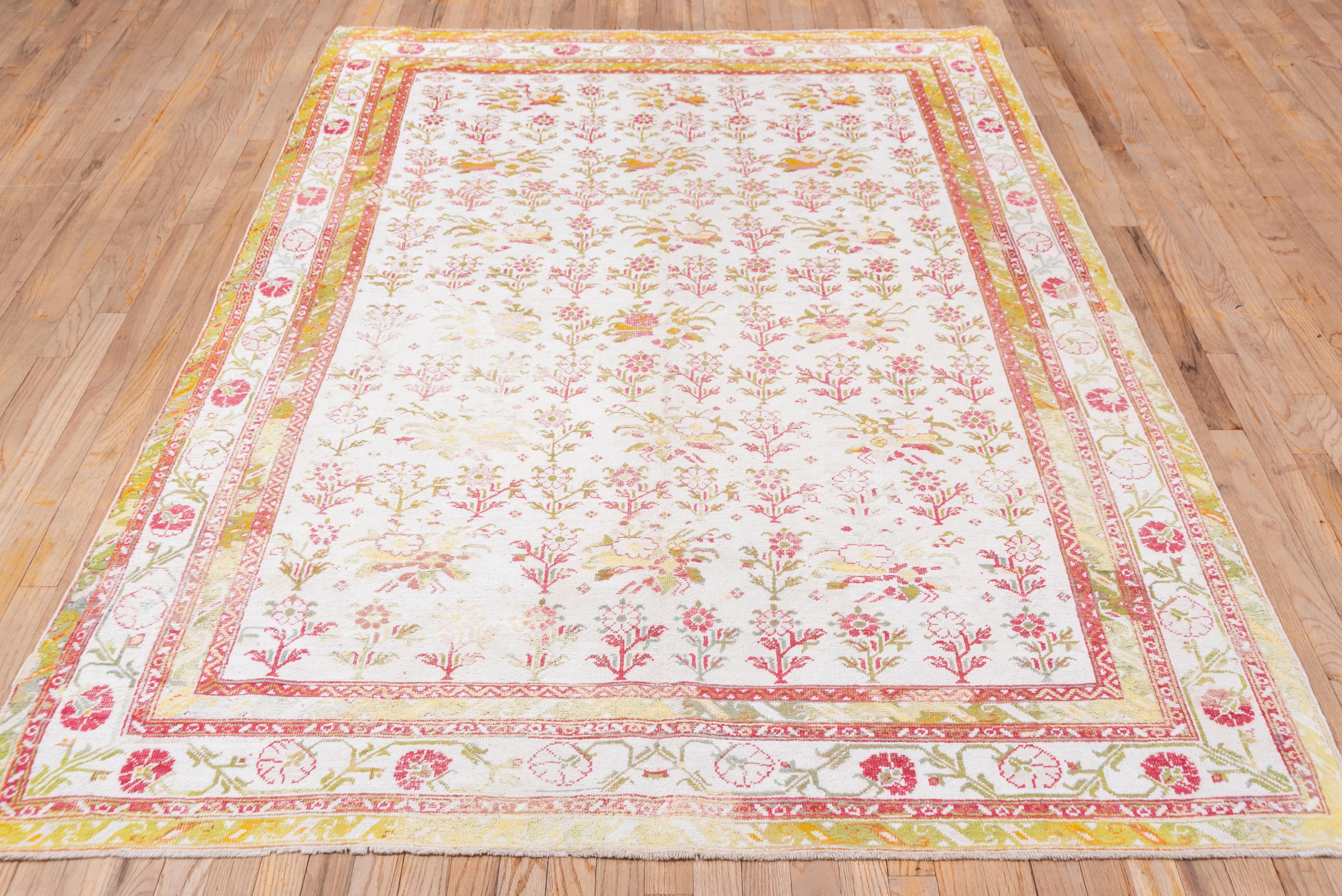 The age is indicated by the selective color corrosion in the dark brown, but otherwise the condition is fairly good. Cotton pile rugs were almost all produced in Agra in northern India and have light palettes. The cream field shows stemmed flower