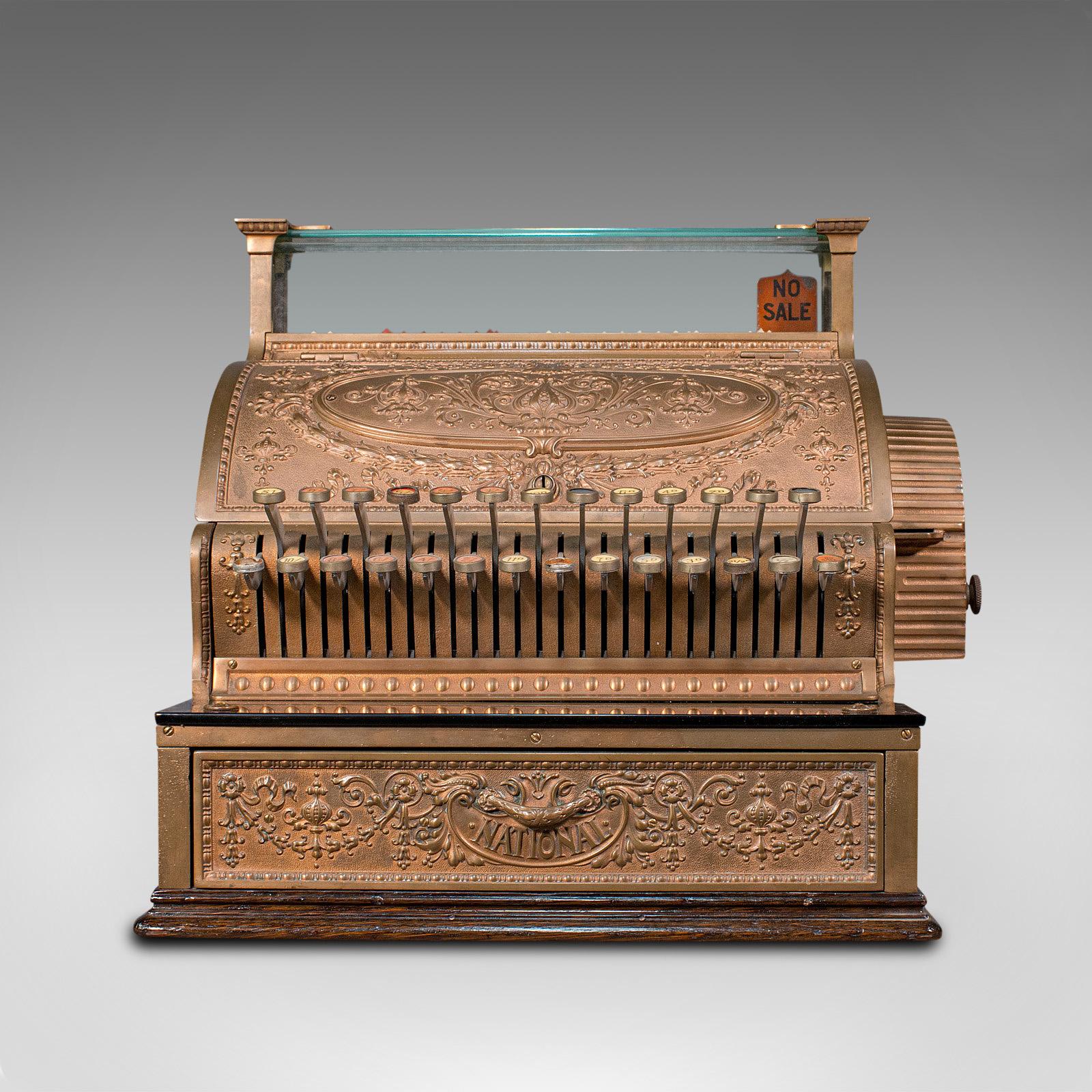 This is an antique countertop cash register. An American, decorative bronze Pound Sterling shop till by National Cash Register of Ohio, dating to the Edwardian period with a 1905 serial number.

Strikingly decorative antique cash register