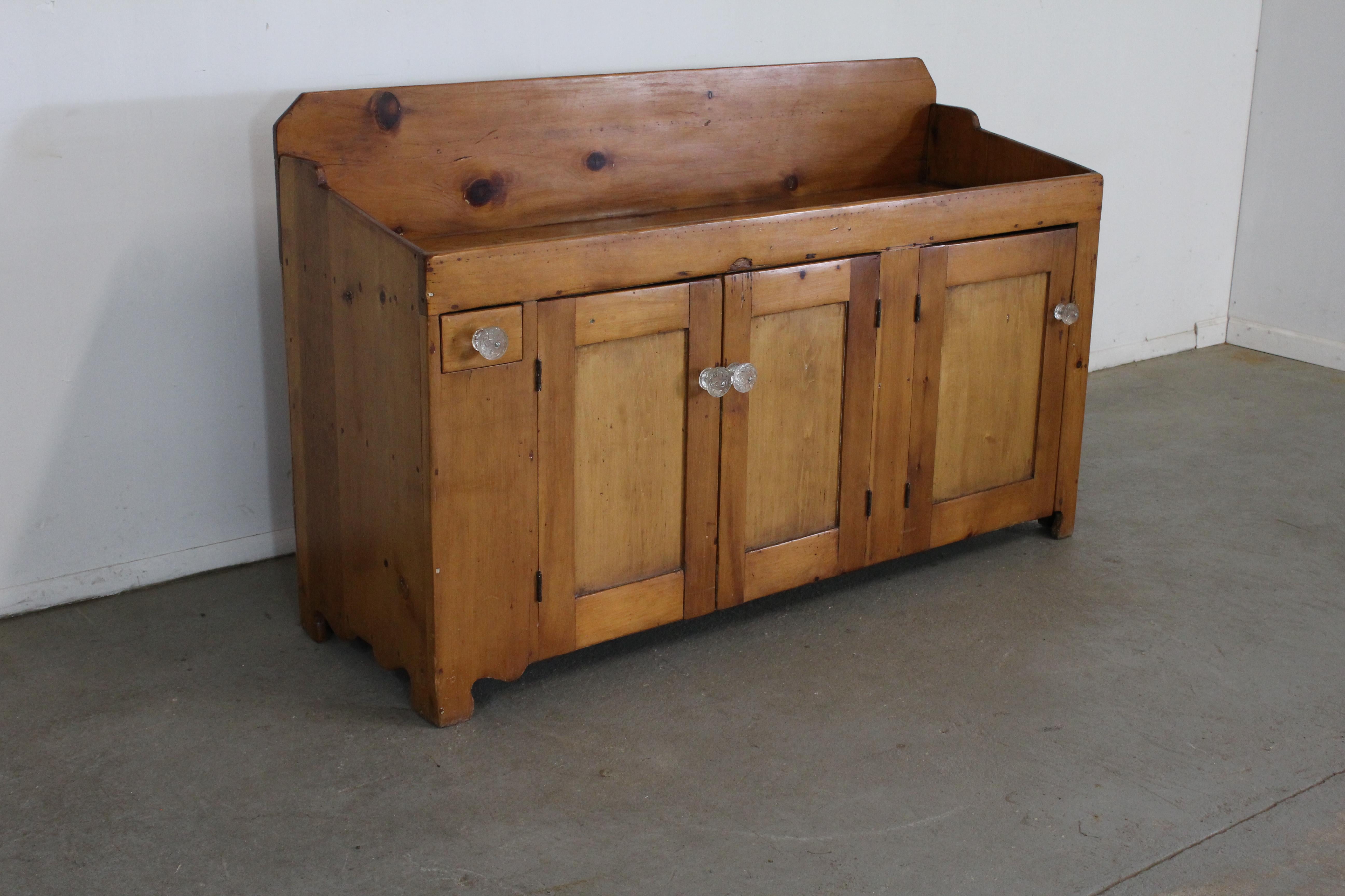 Offered is a solid Pine wood Antique Country Elongated dry sink. We estimate his to be from the mid to late 1800's. It features 1 small drawer and 3 doors with loads of storage. This piece has been in our personal home for the last 15 years. We have