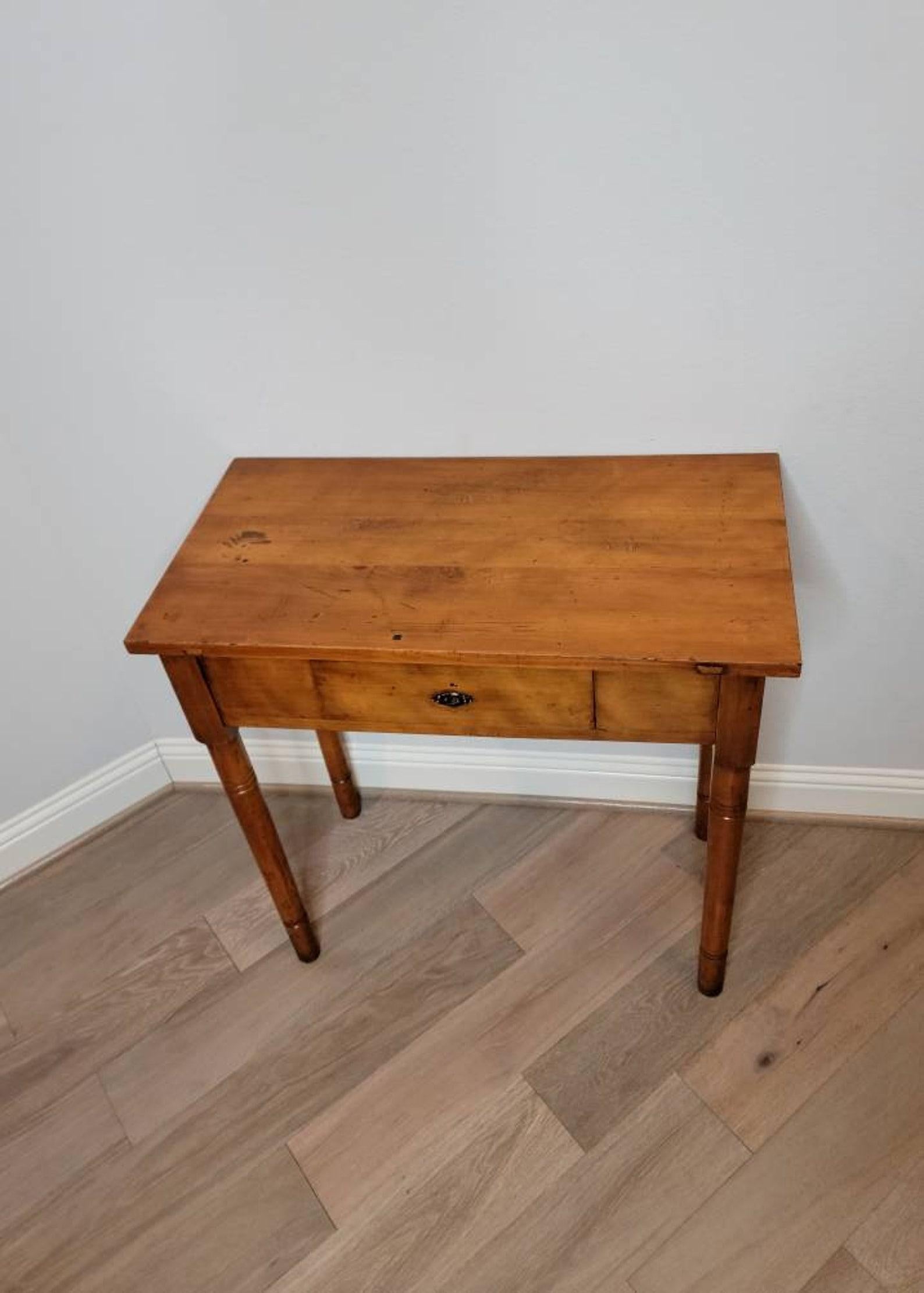 An antique country European farmhouse kitchen work table / writing table with beautiful rich patina. 

Born in the 19th century, hand-crafted of solid pine, the simple form enhanced by complex pine wood grain detail patterns, honey coloring, and