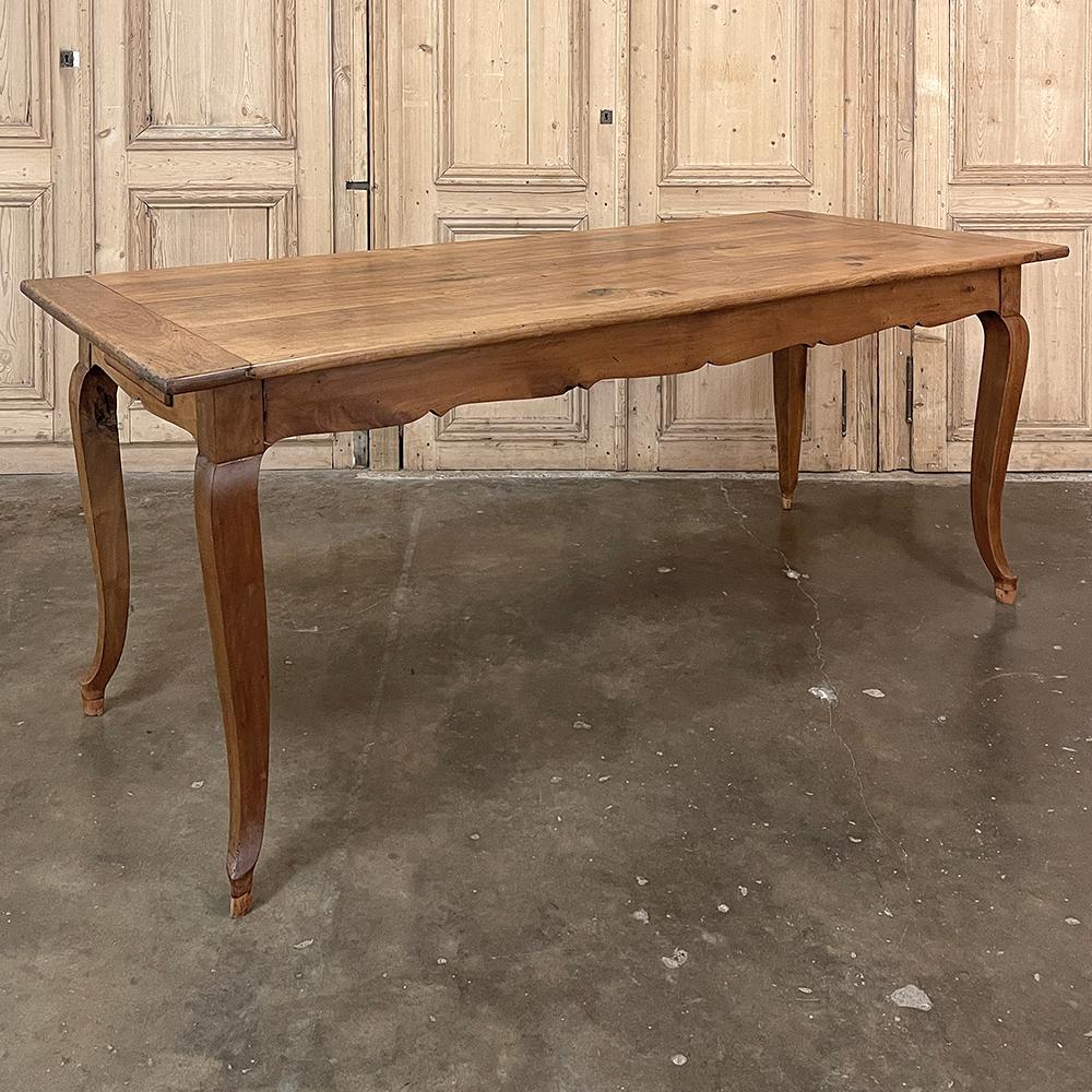Antique Country French Cherry Wood Dining Table combines the capable craftsmanship of skilled rural artisans with the richness of aged, patinaed cherry wood to create a warm and welcoming dining table ready to take center stage in the room!  Only
