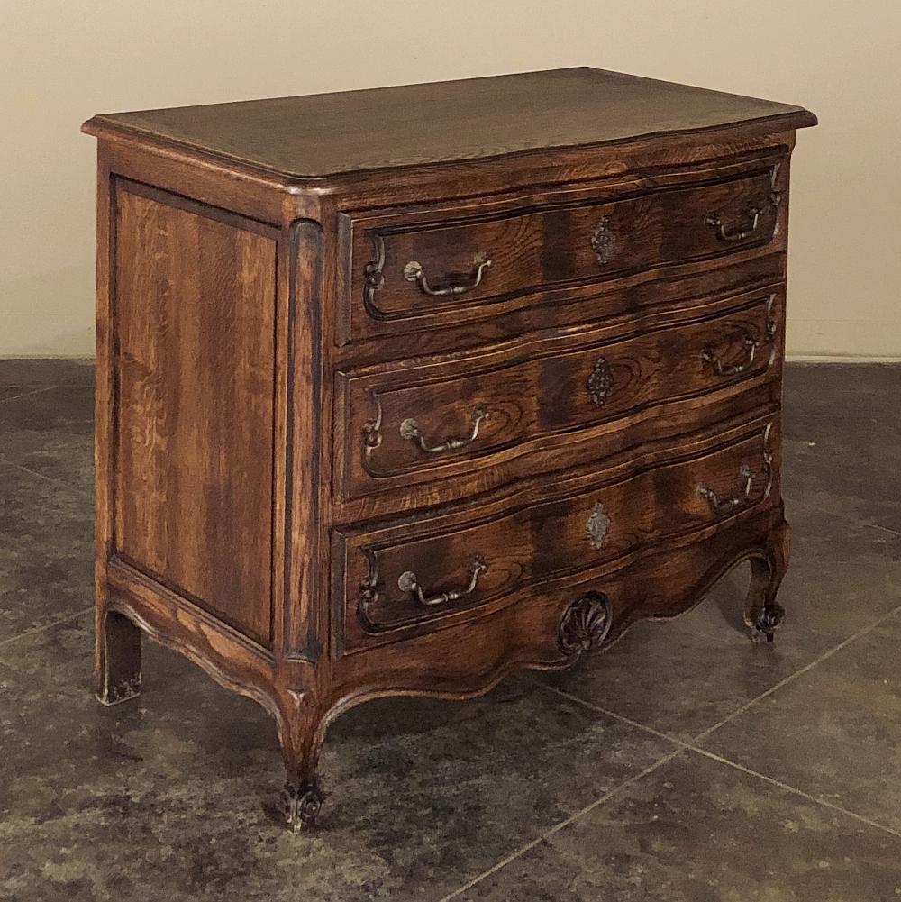 Antique Country French Commode captures the essence of the provincial style! Rendered from solid chestnut, it features a tailored look yet with subtle French flair exuding from the contoured drawer facades and gently undulating apron. Carved