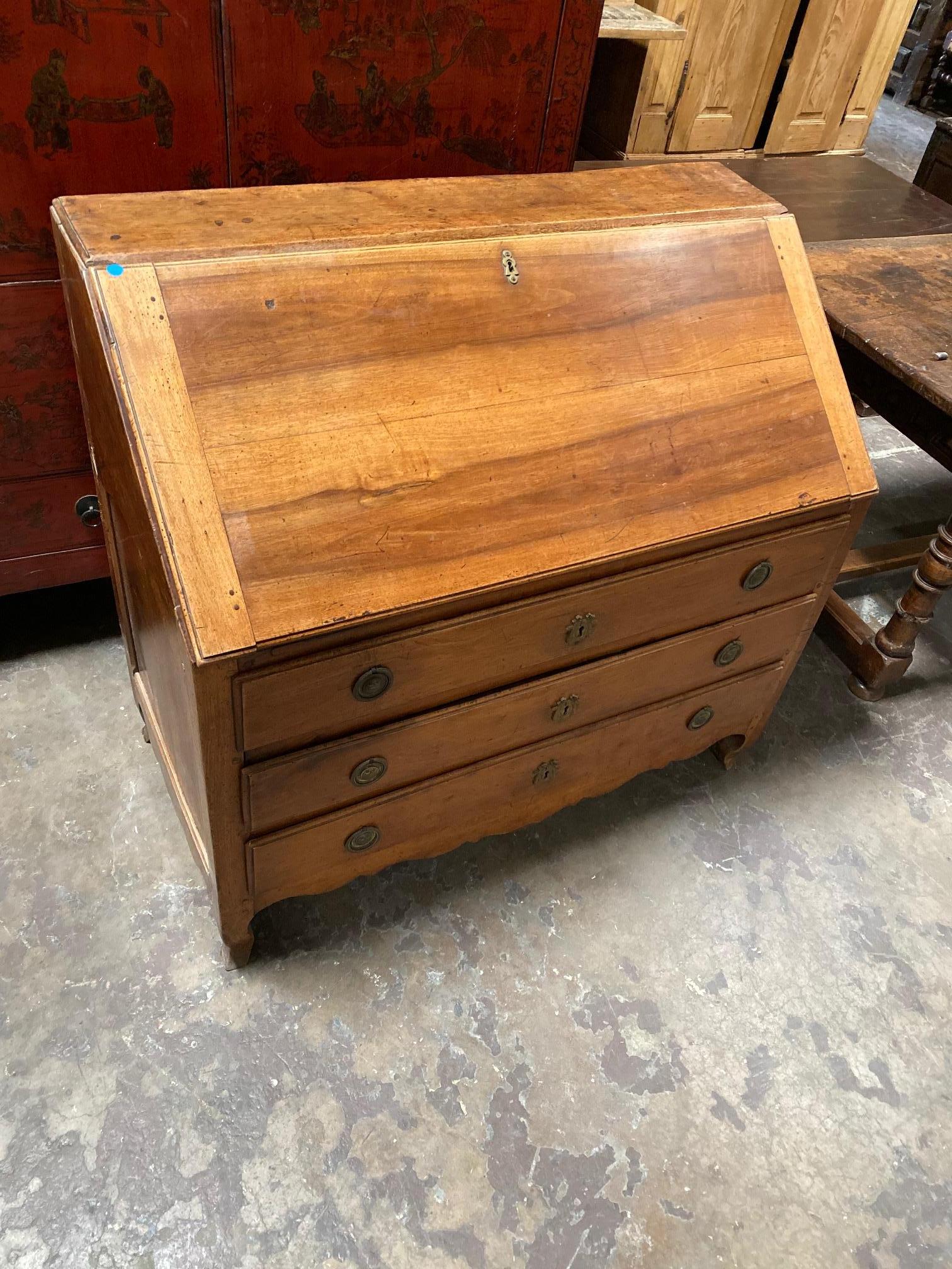 This French desk is made of walnut and dates back to 1800. 

Measurements: 44” W x 41” H x 23” D (desk tucked in) 42” D (desk pulled out).
  
        