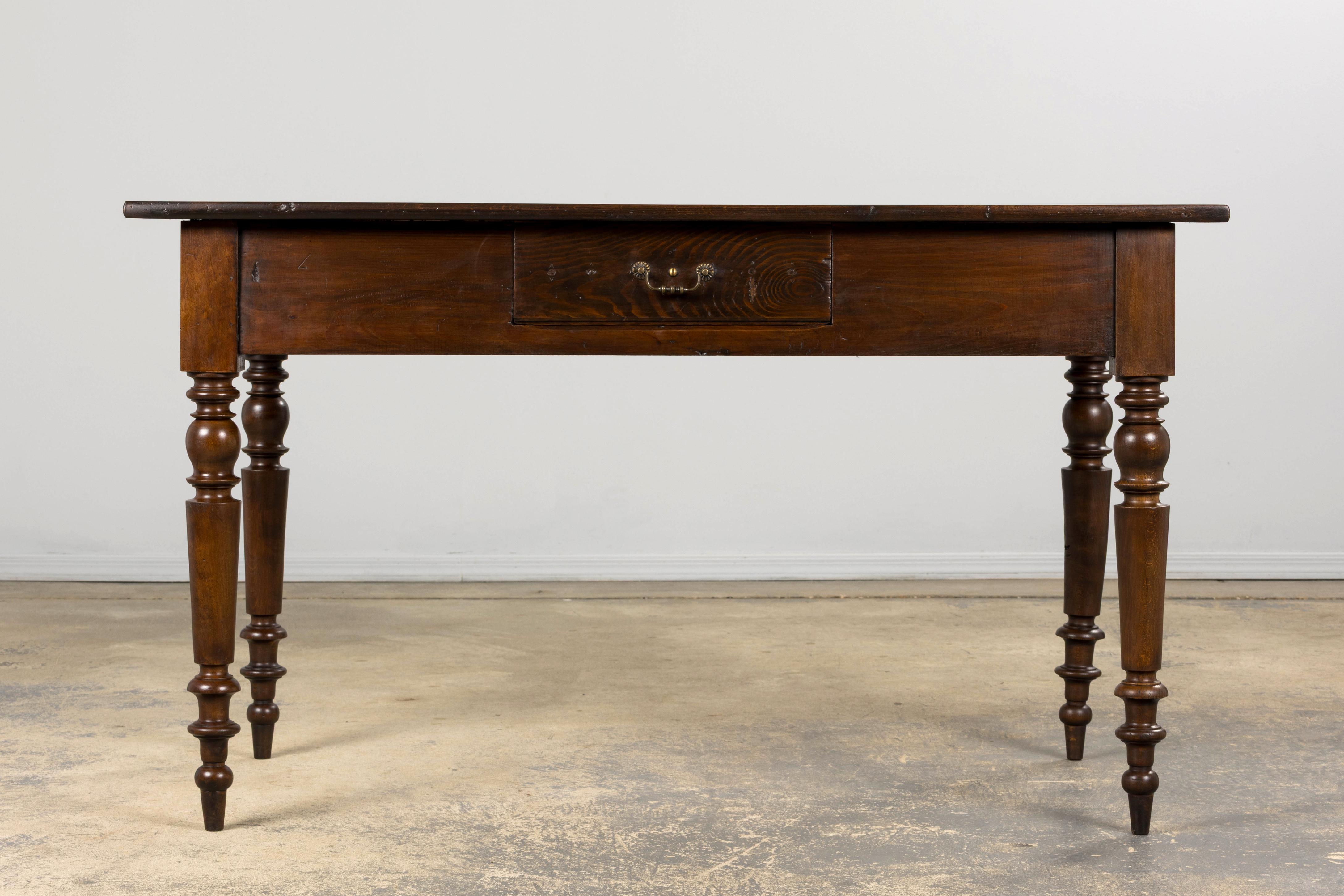 A charming late 19th-century French Provincial table in the Louis Philippe style, sourced from Provence. Expertly hand-crafted from solid maple, it features a 4'5