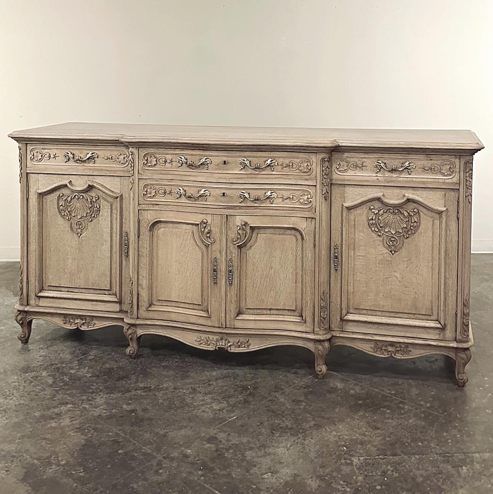 Antique Country French Louis XIV Step-Front Stripped Oak Buffet is an incredible expression of French style and sophistication, yet executed in stripped oak with a relaxed Country French flair that makes it compatible with an entire host of