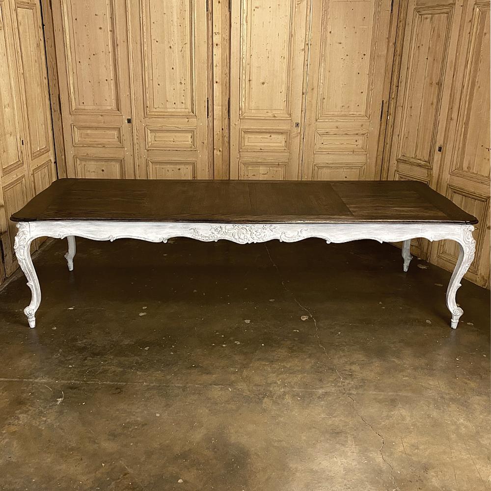 Antique Country French Louis XV carved and painted banquet table is a magnificent work, and perfect for the large family or for those who like to entertain! Handcrafted from old growth oak, it features a stained and sealed contoured and beveled top