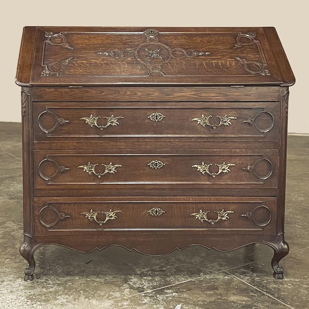 Antique Country French Oak Secretary is a superb example of this most efficient form of cabinetry. Combining a chest of drawers with a desk, it works in any situation where efficiency is paramount. Hand-crafted from solid oak, the slant front with