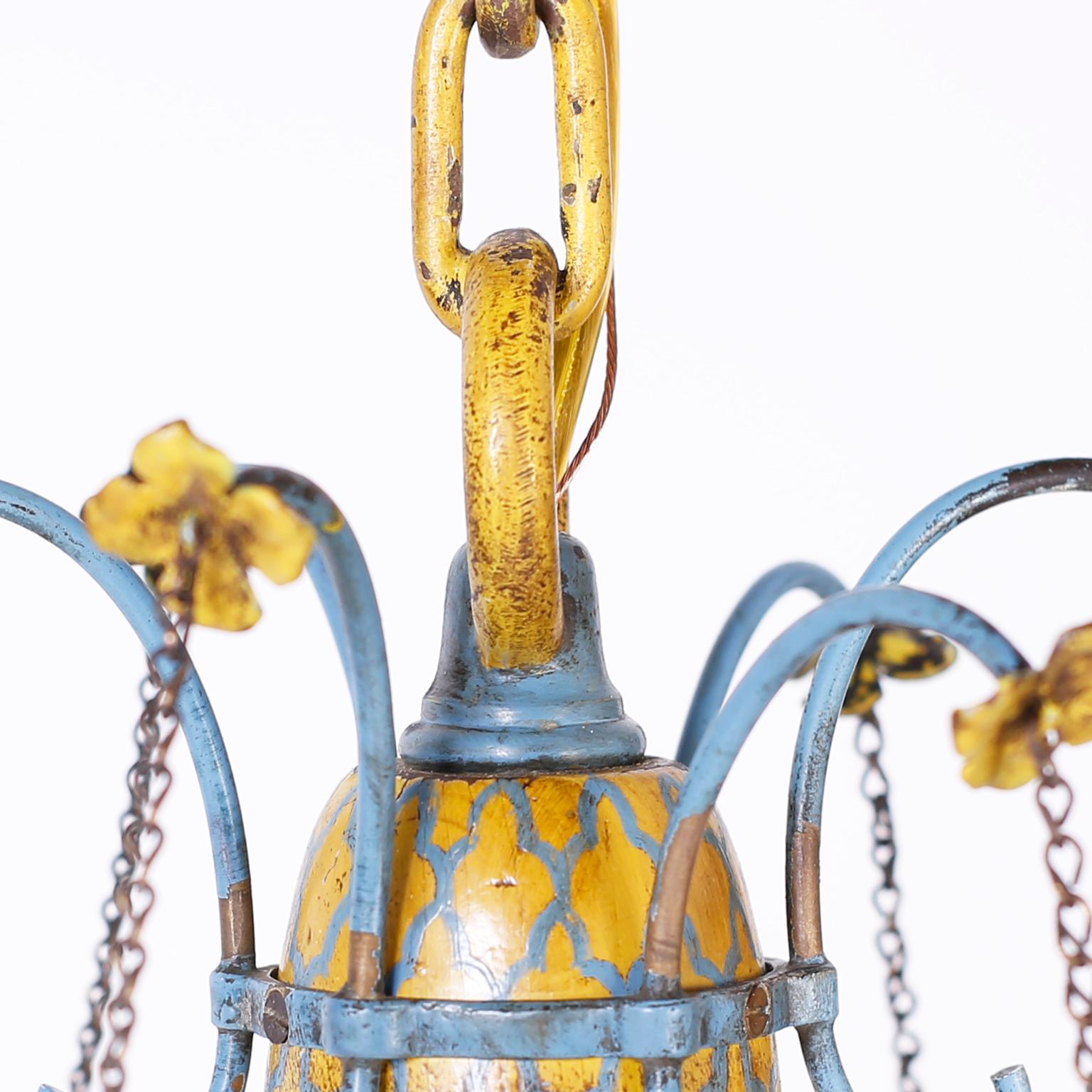 Electrifying antique French six-light chandelier crafted with a Classic blue and yellow painted stem and elegant blue painted metal arms with yellow flowers as only the French can do.