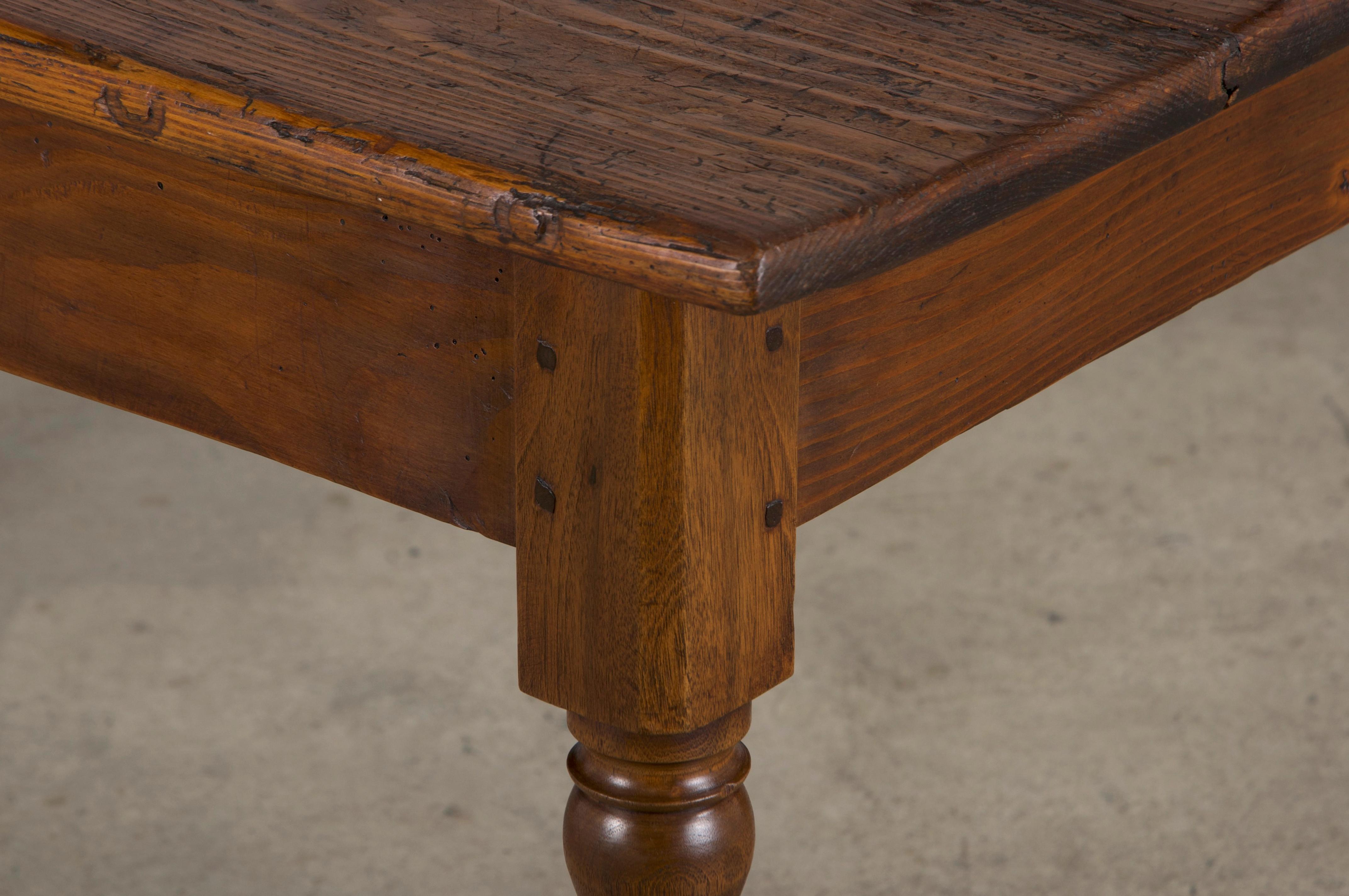 A rustic, late 19th-century French provincial farmhouse table, versatile as a kitchen table, dining table, or desk, sourced from Provence, France. Handcrafted from solid mixed woods, it features a 4'2