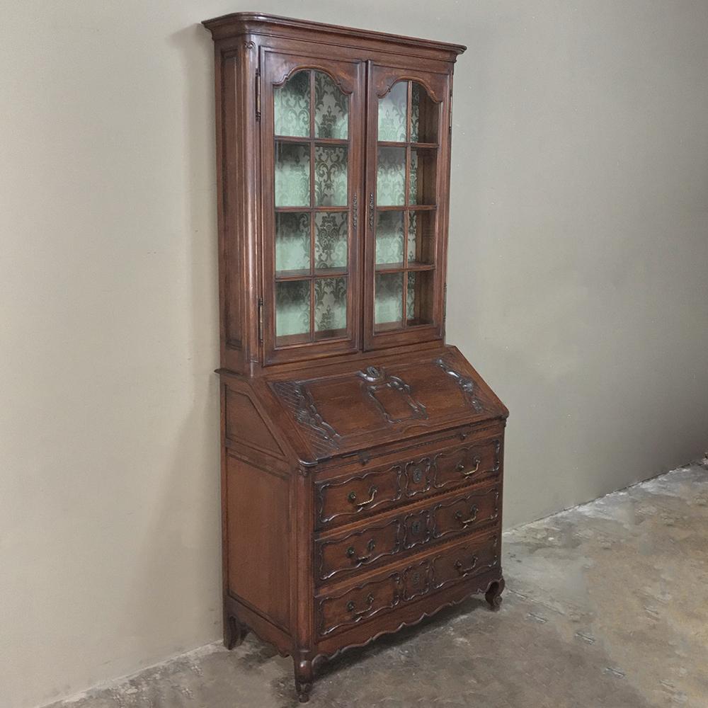 Antique Country French Provincial secretary, bookcase features display above, storage below, and a slant-front, drop-down work surface that is ideal for 21st century workplaces! Hand carved and crafted from solid oak to last for generations,
circa