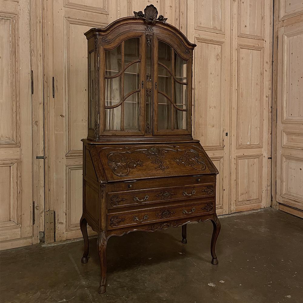Antique Country French Regence style secretary ~ Bookcase combines elegant display above with storage below and a drop-front desktop surface ~ all rolled into one! The boldly arched crown centered with a shell with foliate sprays overlooks the