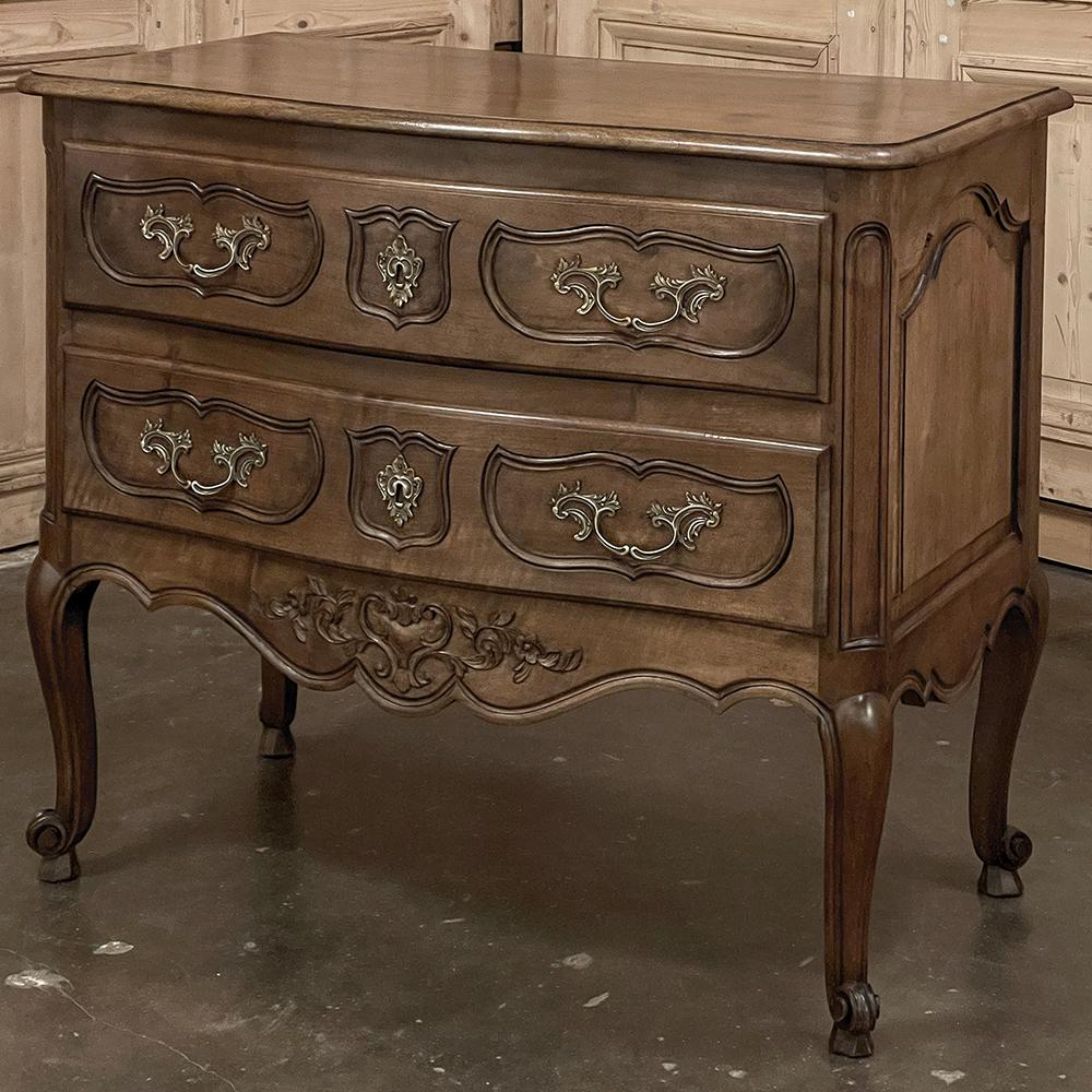 Antique Country French Regence Walnut Commode was hand-crafted from the premier indigenous hardwood of Europe, sumptuous French walnut!  The beveled top features a subtle bowed contour along the front, with the remainder of the facade following the