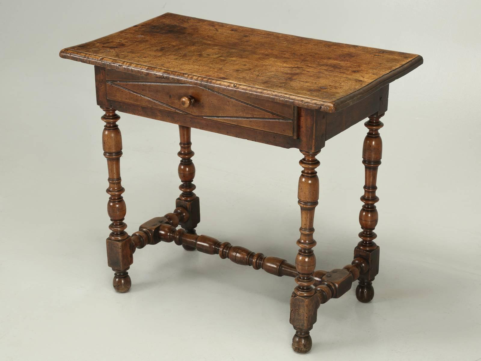 Antique Country French side or end table, dating all the way back to the early 1700s. The top is made from one magnificent board of walnut and almost looks burl. The expert in France wrote; époque, beginning of the XVIIIeme. So, our antique French