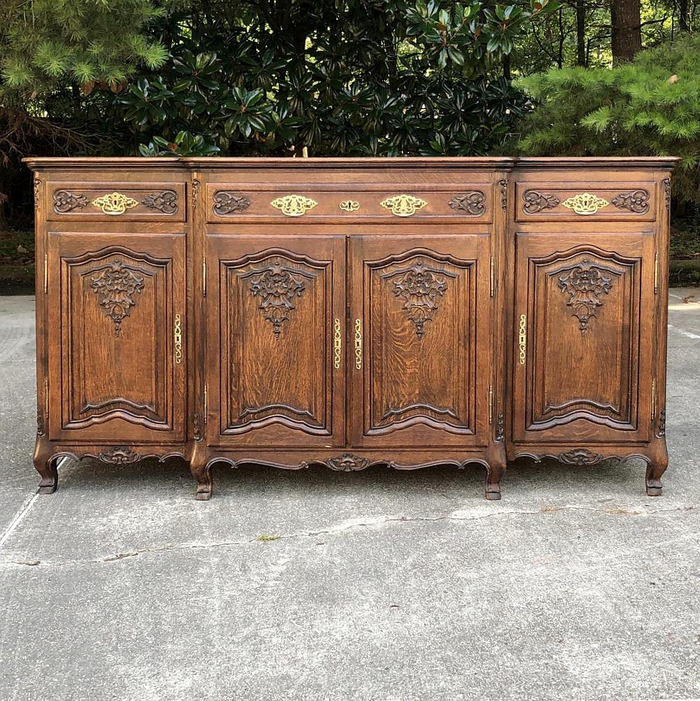 Antique Country French step-front buffet is a marvelous example of the culmination of centuries of French furniture craftsmanship! Created from solid oak to last for generations, it features a step-front design that creates more visual intrigue, as
