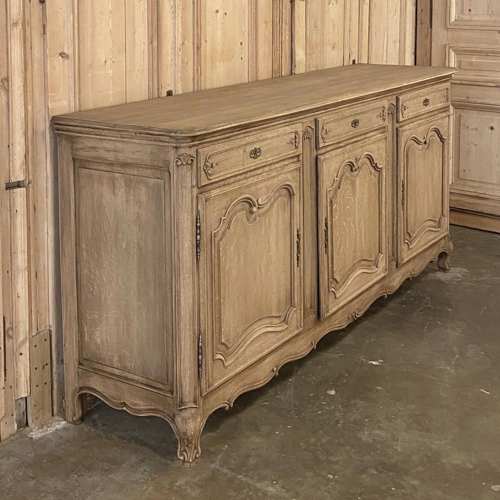 Antique country French stripped oak buffet features elegant yet restrained lines with just a hint of carved detail, otherwise the scrolled and naturalistic form of the framework itself provides adornment! Called a trois porte enfilade in France,