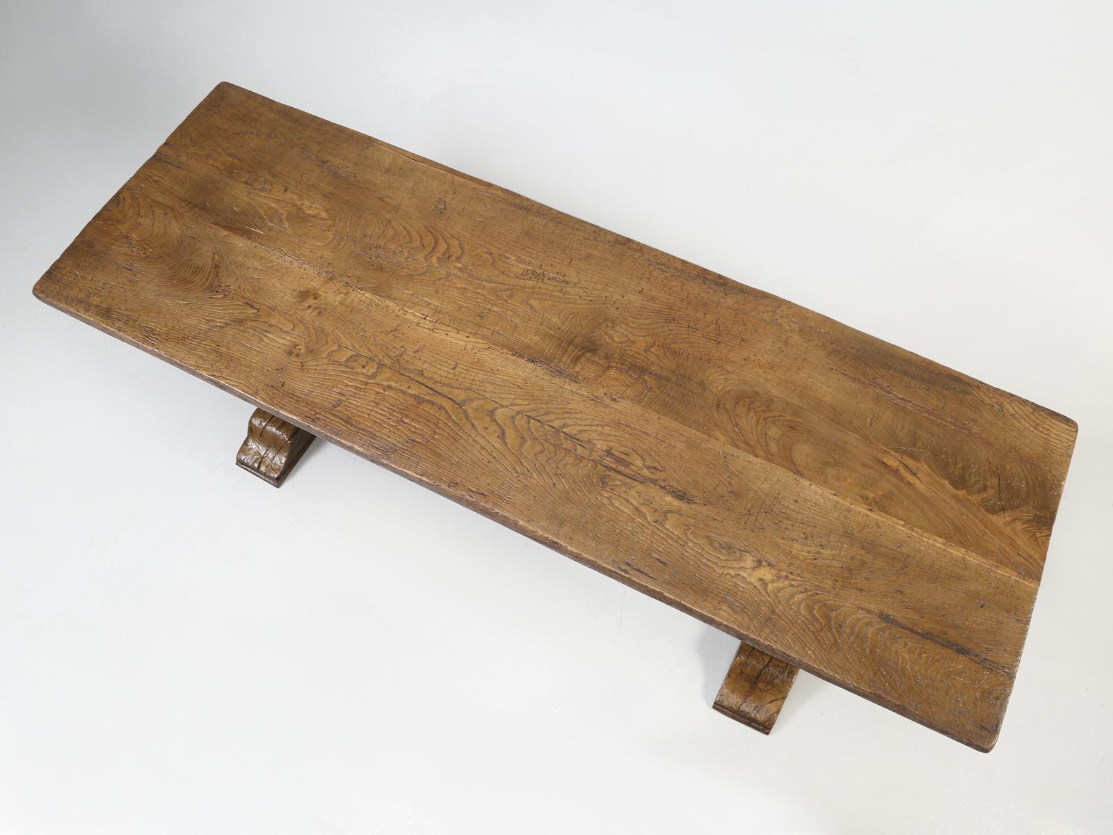 Country French antique rustic trestle style dining or kitchen table, that dates back over well over 100 years with a two-board top, which is always an indicator of a very old table. Our in house Old Plank restoration department, completely