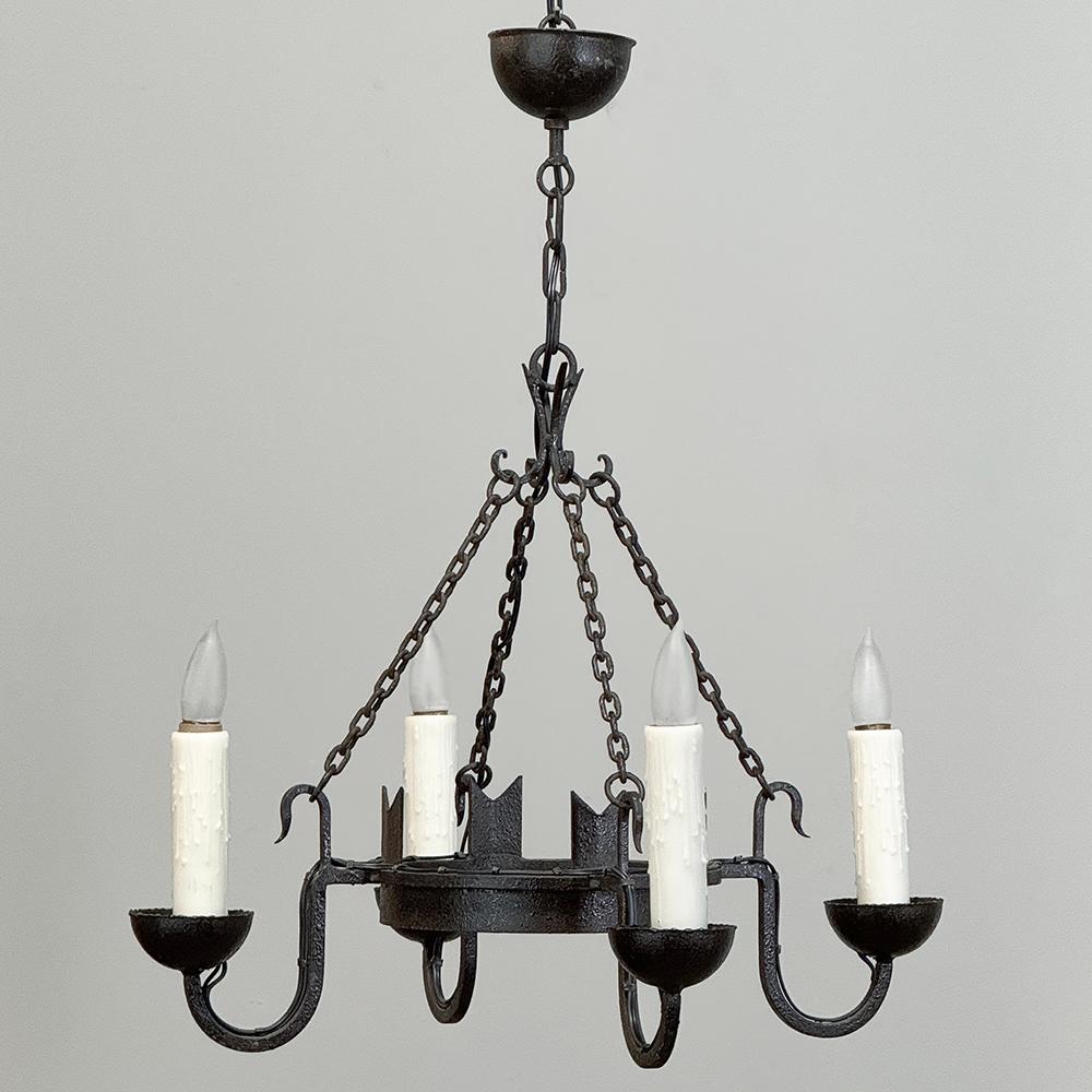 Antique Country French Wrought Iron Chandelier combines a tailored, rustic effect with the durability of wrought iron to create a light fixture that will easily outlast your home!  The design is straightforward, with a main hoop upon which four