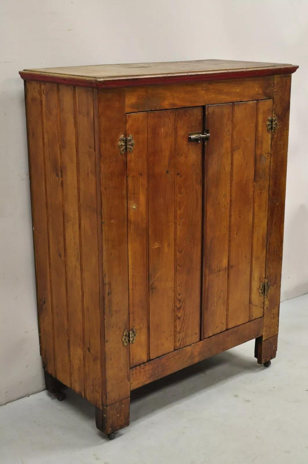 Antique Country Primitive Pine Wood Stained 2 Door Pantry Cupboard Cabinet. Item features rolling casters, distressed stained finish, interior shelves, very nice antique piece. Circa 19th Century. Measurements: 45