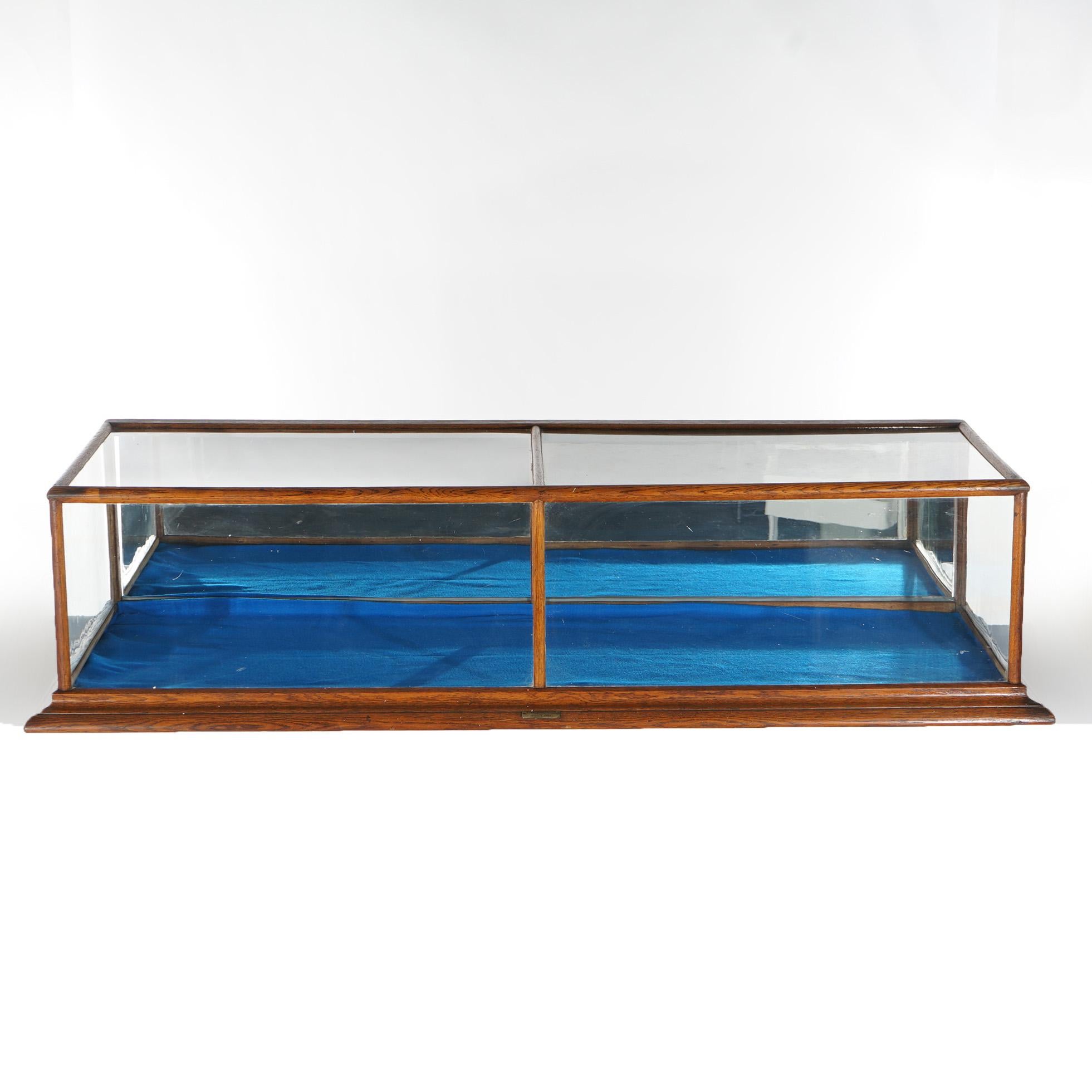 An antique country store table top display case by Burge Huck offers oak frame with glass sides and mirrored interior, maker label as photographed, c1900

Measures - 17.25