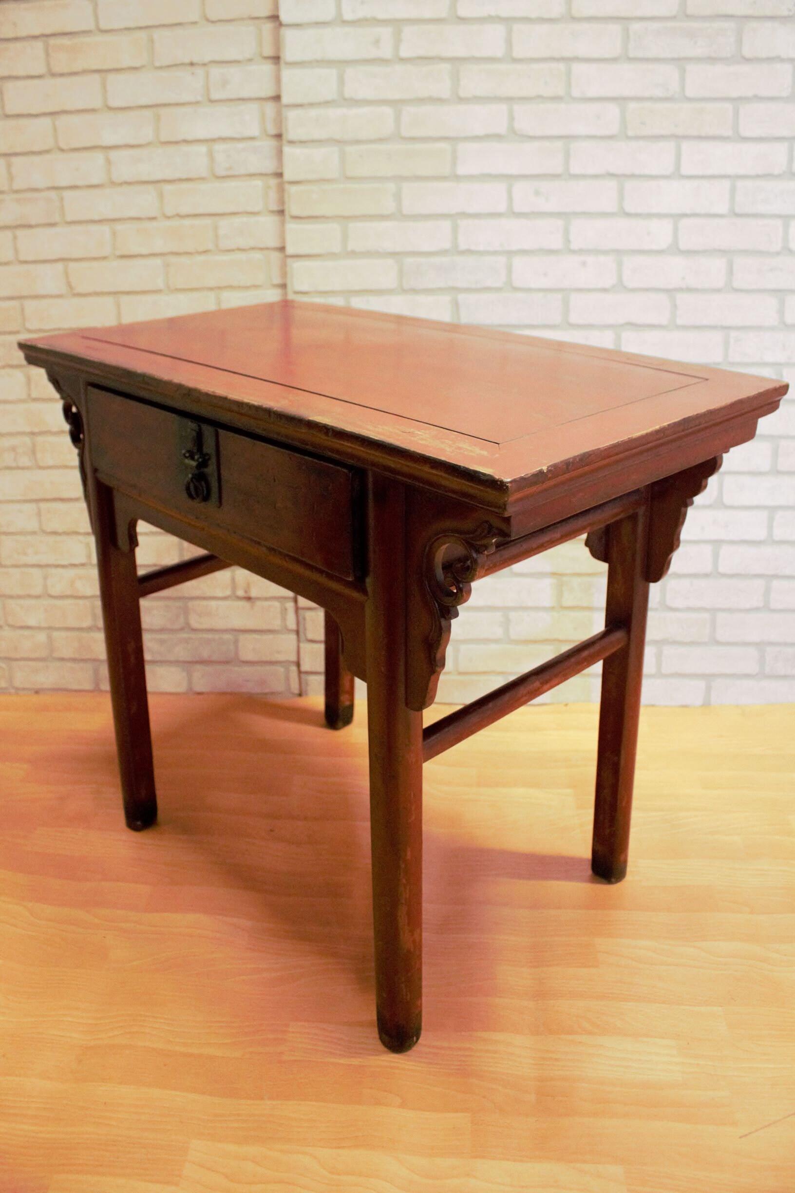 Antique Country-Style Chinese Red Lacquer Altar Desk/Console Table

This small Chinese red lacquer altar table has a top with mitered corners over a pair of brackets centering a single drawer with a brass pull. The inset apron on four canted legs is