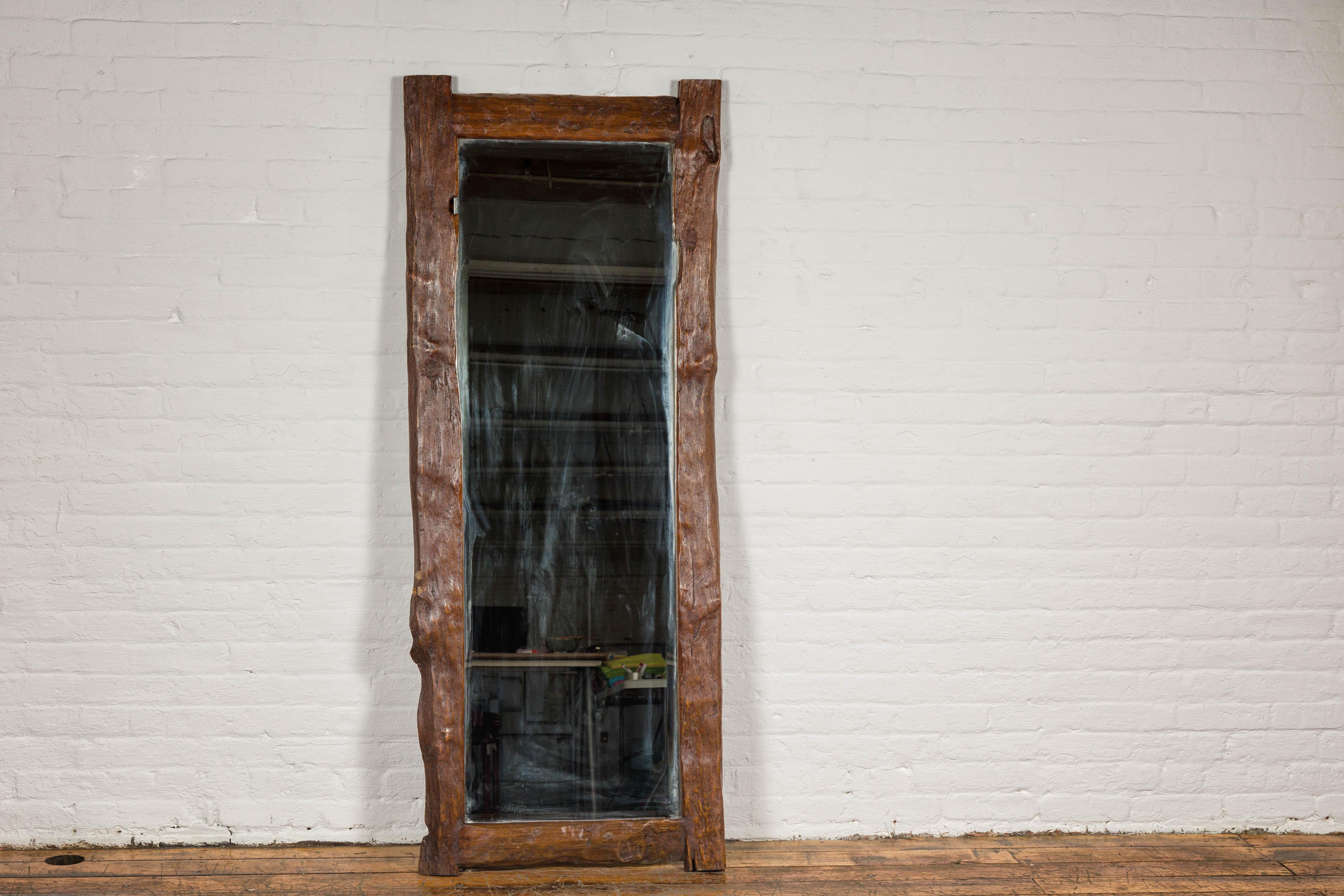 Country style antique driftwood made into a mirror with rustic character and beveled glass. This Country-style antique mirror is exquisitely framed in naturally weathered driftwood, offering a touch of rustic elegance to any interior space. The