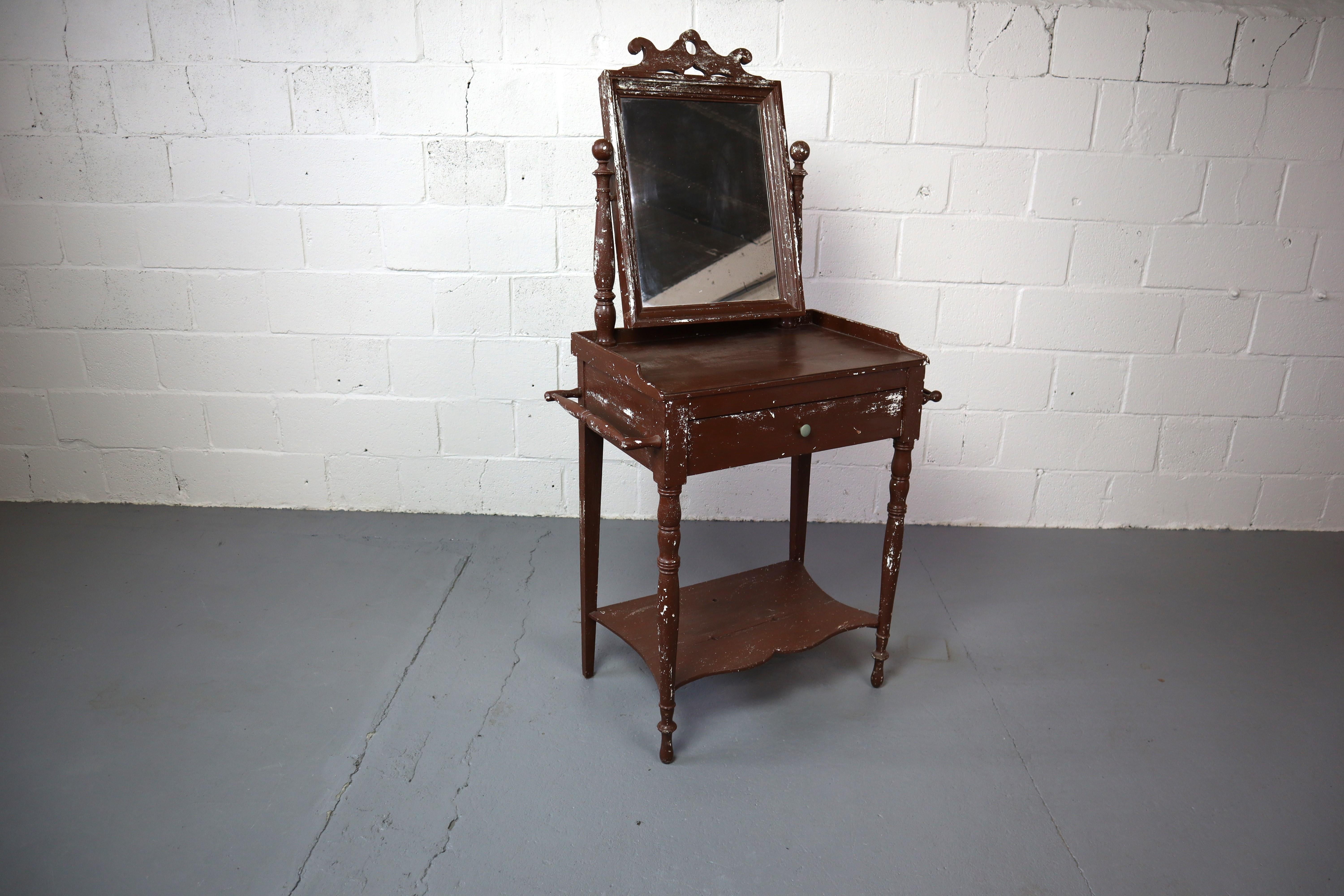 Old rustic French dressing table with weathered paint, weathered mirror and drawer.