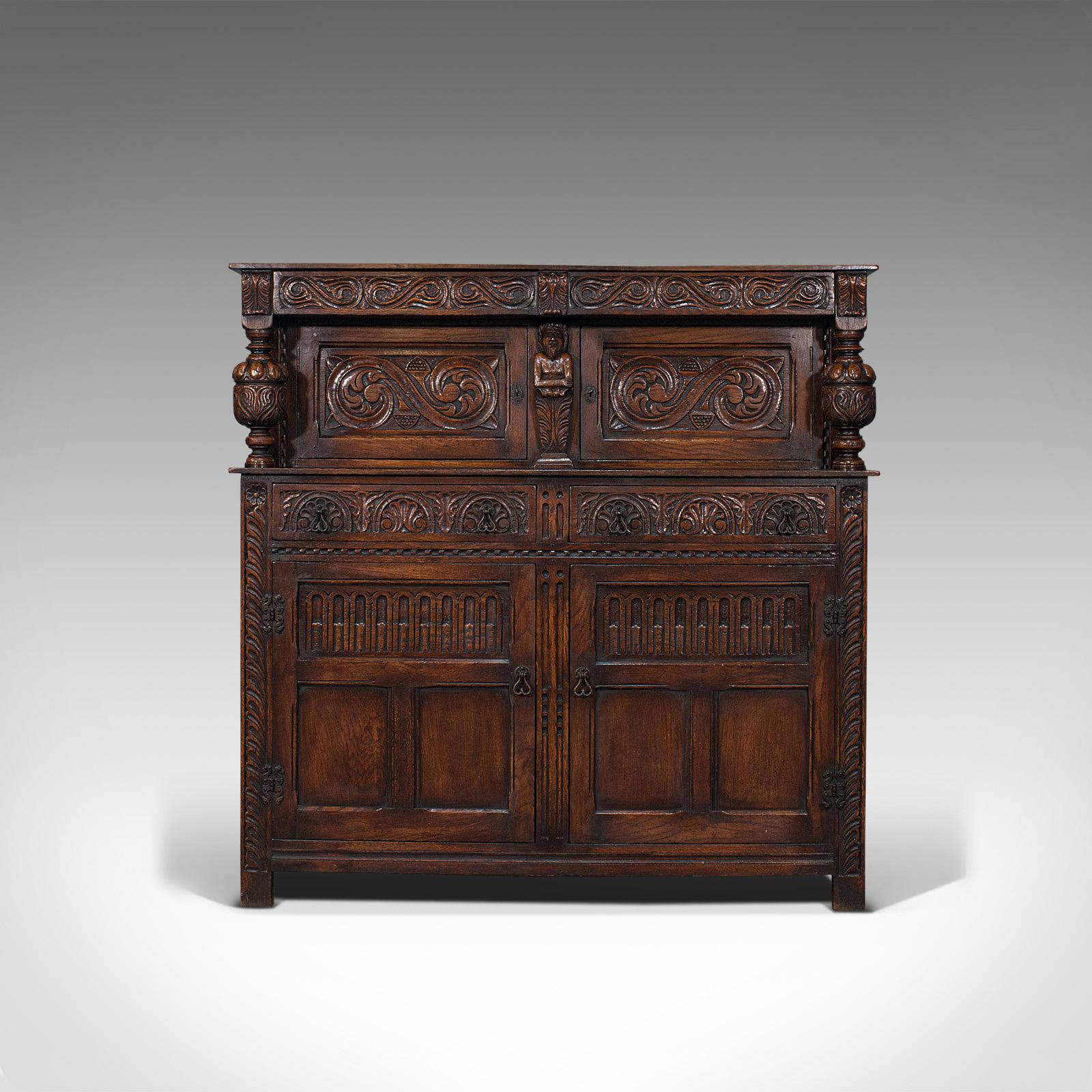 This is an antique court cabinet. An English, oak sideboard or credenza in Jacobean revival taste, dating to the late Victorian period, circa 1890.

Impressive cabinet with fine carved details
Displaying a desirable aged patina
Select oak shows