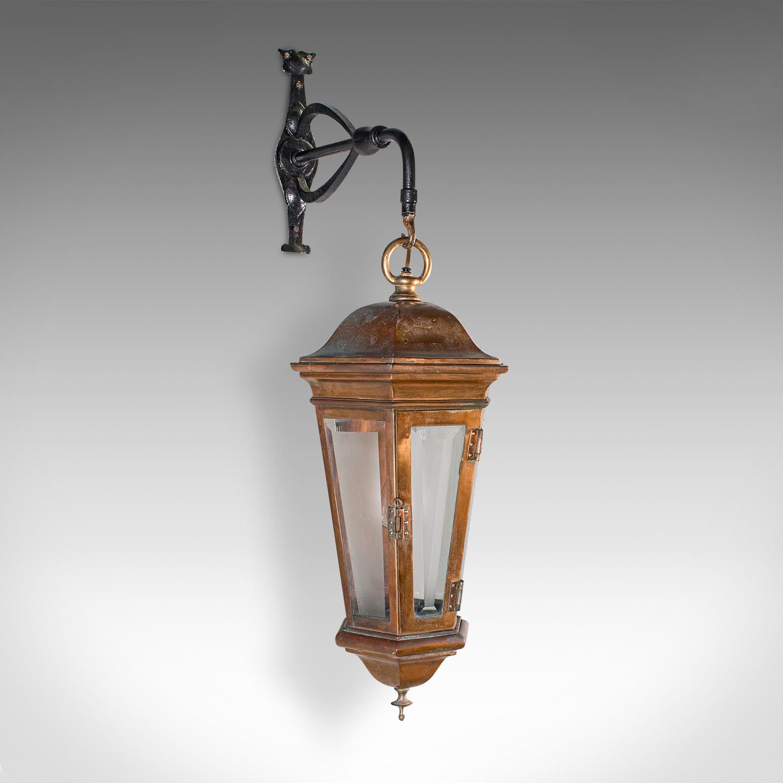This is a large antique courtyard light. An English, bronze and wrought iron carriage lamp, dating to the early Victorian period, circa 1850. With timeless character and period appeal, this superb lamp makes a striking statement in any exterior or