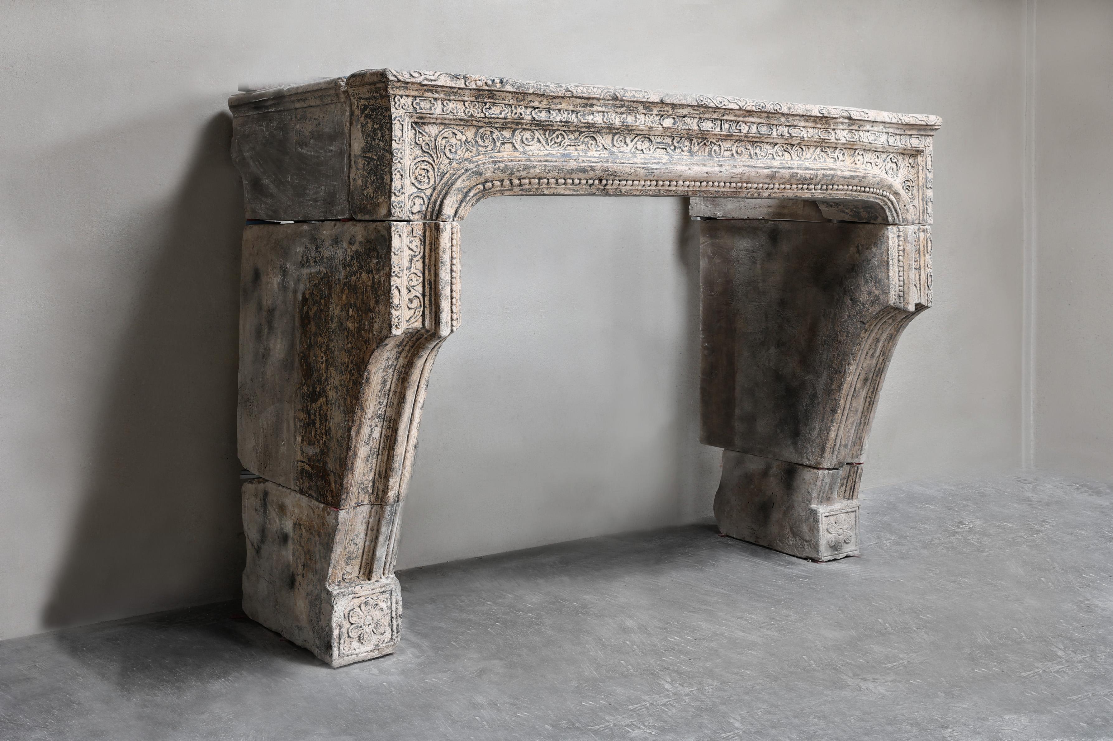 Beautifully crafted mantelpiece of French limestone. This antique mantelpiece comes from an old French castle and dates from the 19th century and is in the style of Louis XIV. The workmanship in this fireplace is done with a lot of handwork and
