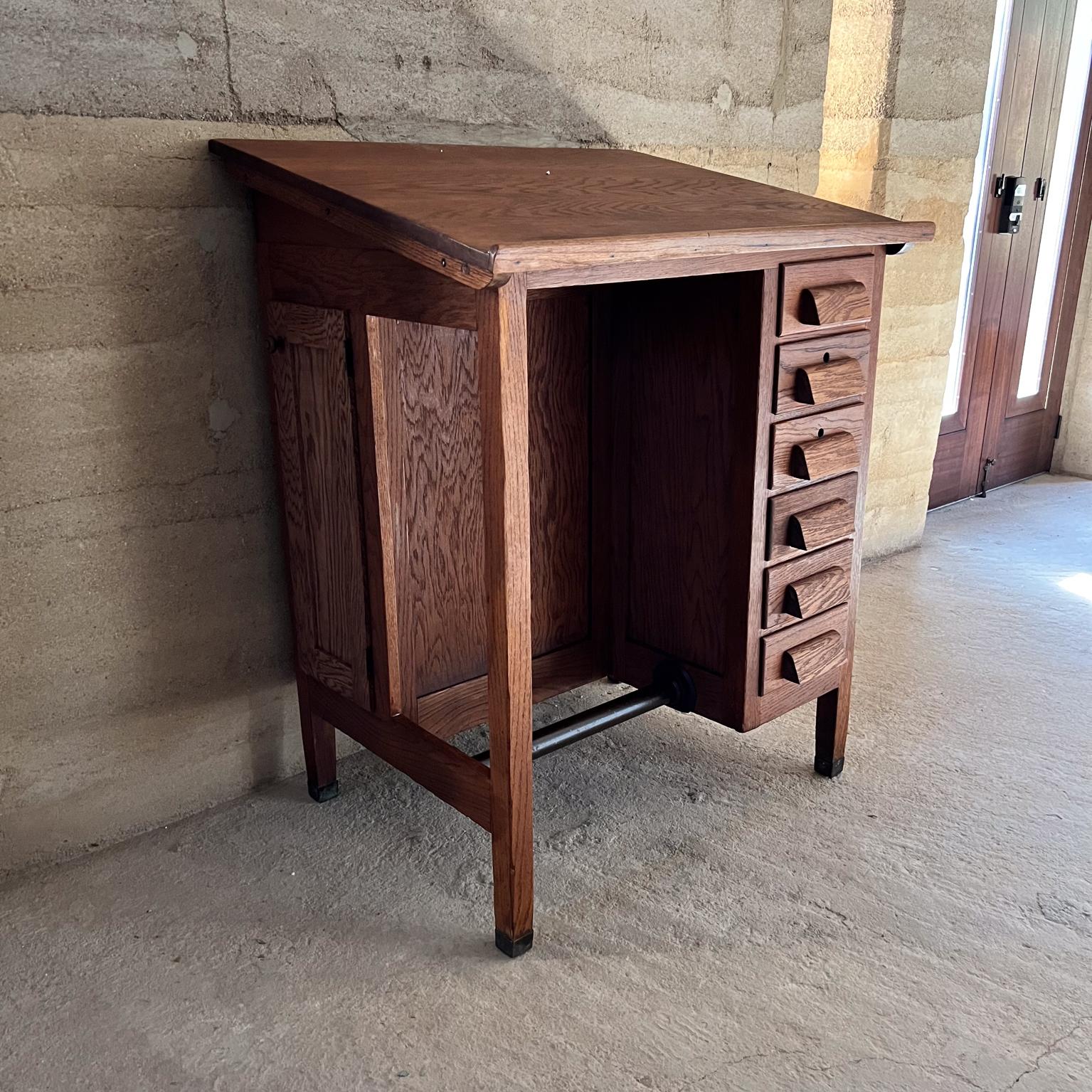 
Stunning Oak Industrial Drafting Table Desk with Drawers Storage
attributed to E.H. Sheldon & Co
45 h at tallest, 40 h at shortest x 36 w x 28.5 d
Antique craftsman drafting table constructed with solid oak wood brass sabots original