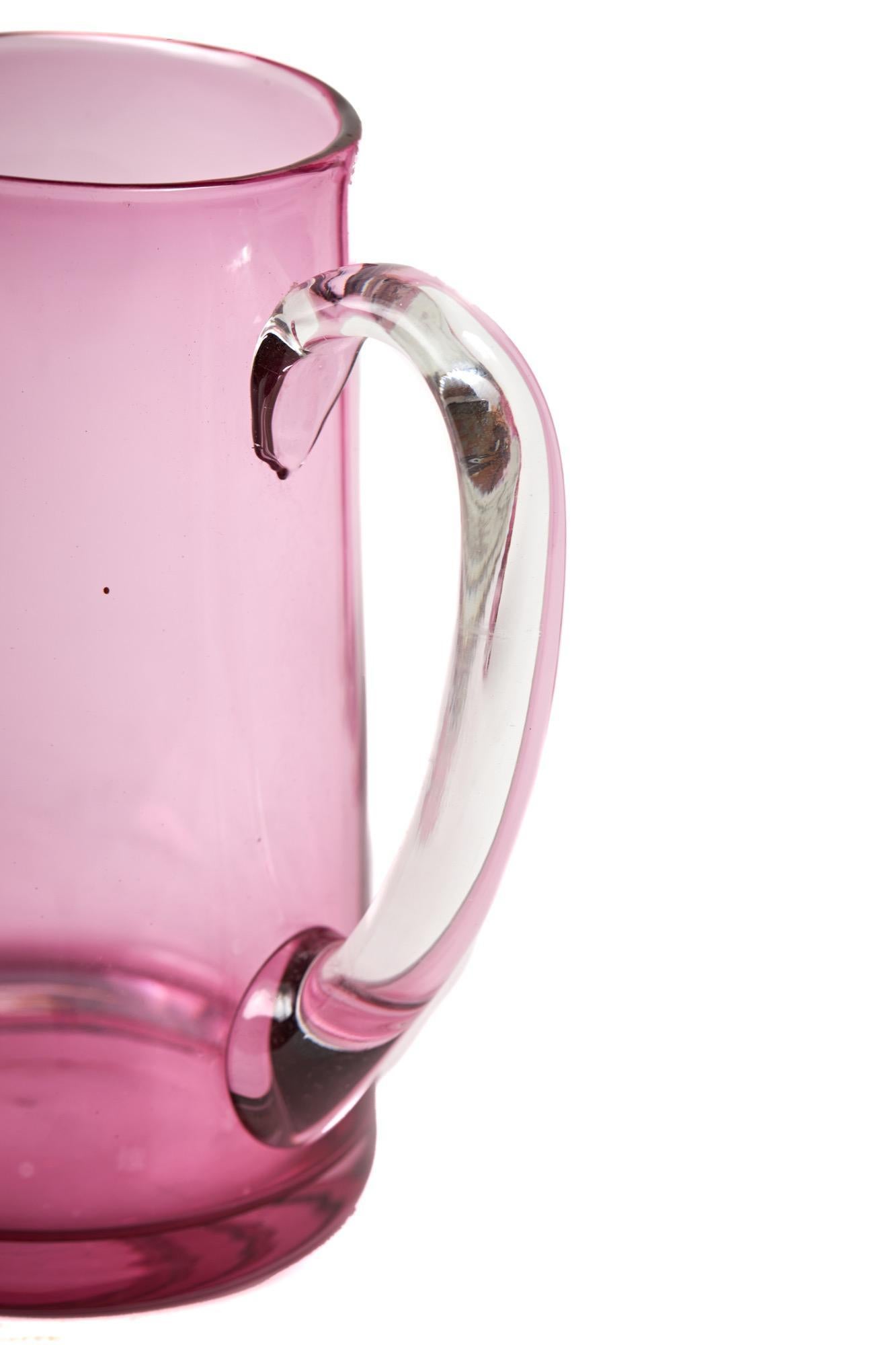 Antique Cranberry Jug With 6 Antique Glasses, the jug is lovely and simple in design having a clear glass cranberry body with a clear glass handle and 6 clear cranberry glasses. Great overall condition and lovely colour.

Jug - Height 18cm Width