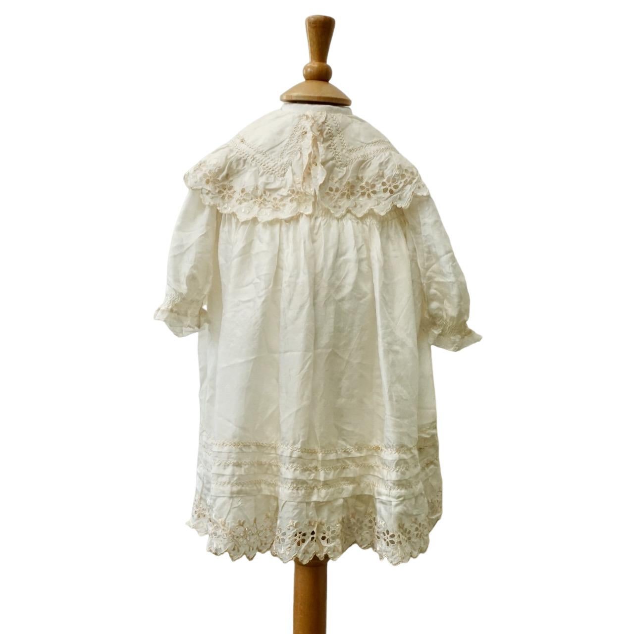 Beautiful antique cream silk christening gown, and a white cotton christening gown.

The lovely antique fine cream silk gown has broderie anglaise embroidery to the collar and hem, and smocking detail, the sleeves are finished with lace. The back