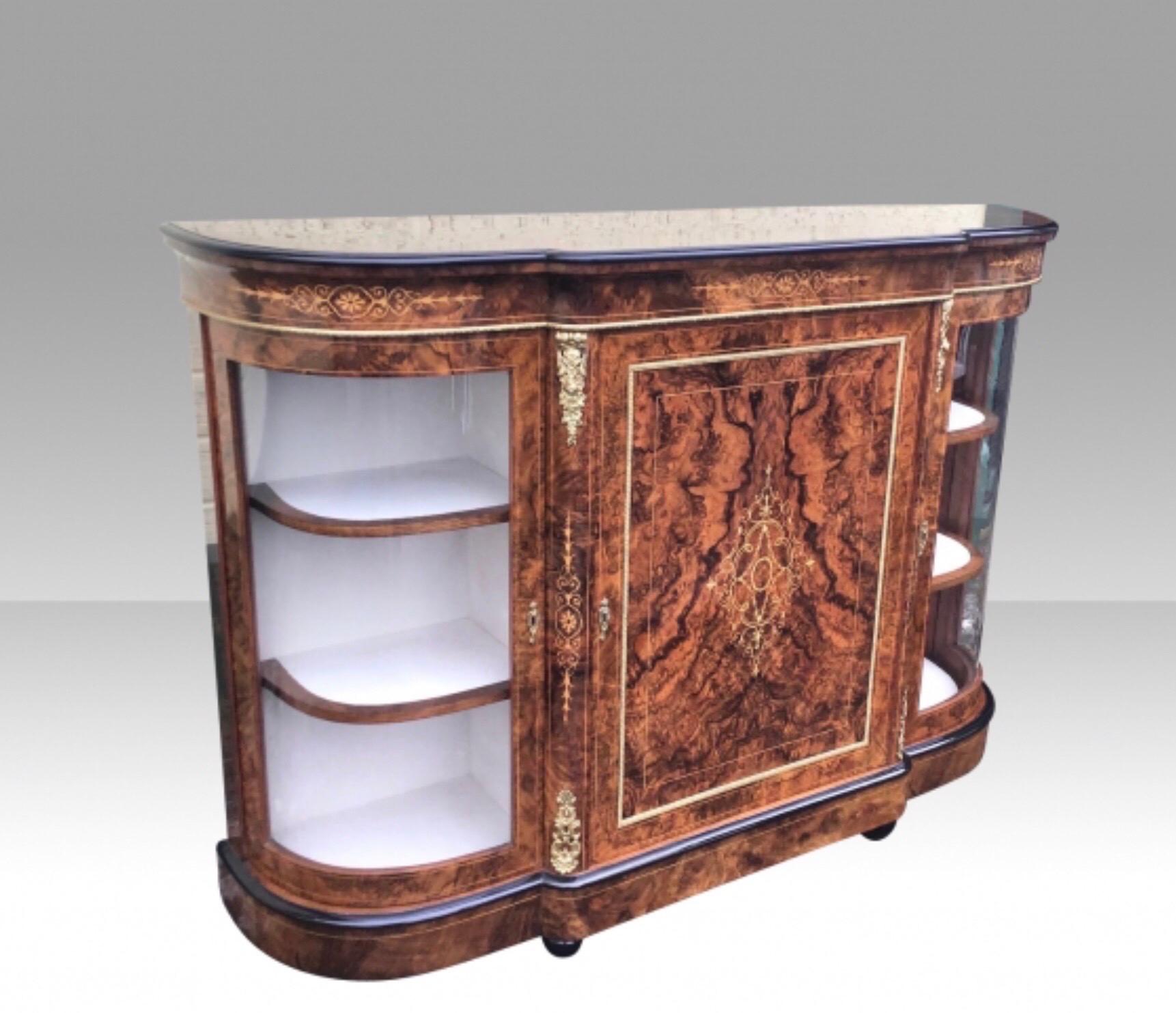 Fabulous exhibition quality figured and burr walnut antique credenza cabinet sideboard.
A stunning quality Victorian figured and burr walnut and gilt ormolu mounted antique credenza cabinet sideboard with central hinged door flanked by glazed bowed