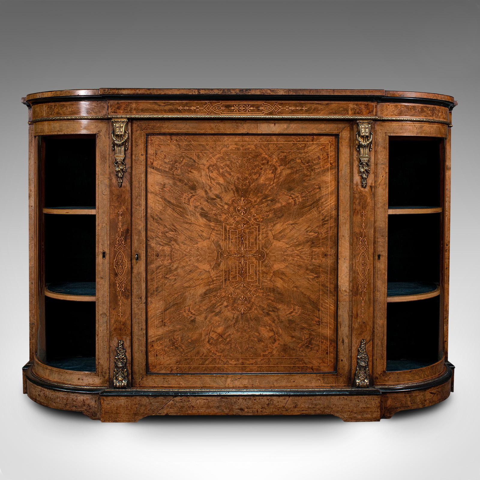 This is an antique credenza. An English, burr walnut sideboard or display cabinet, dating to the Regency period, circa 1820.

Striking craftsmanship testament to the inherent quality of this credenza
Displaying a desirable aged patina and