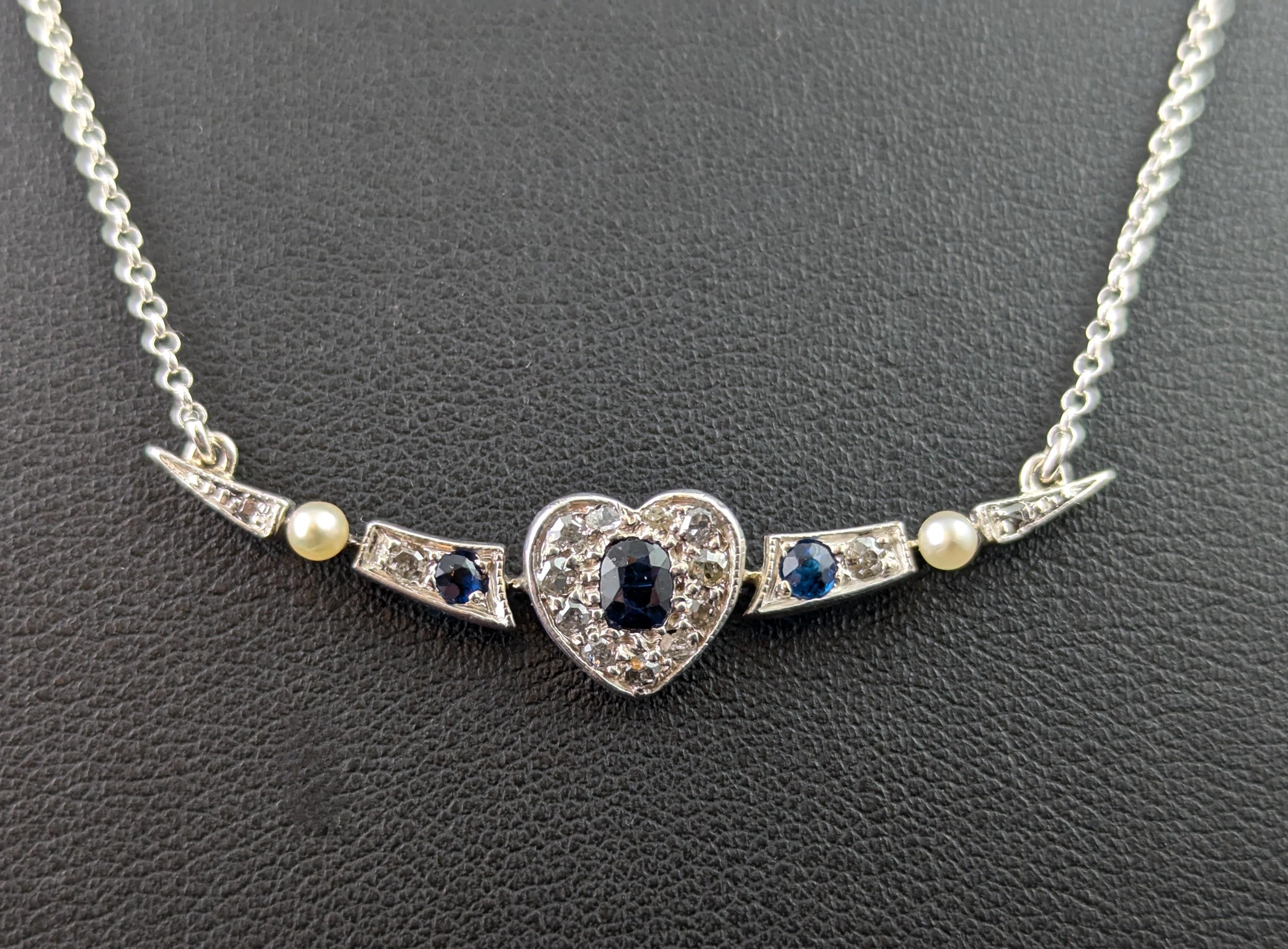 This antique Crescent moon and Heart pendant necklace is simply beautiful!

Such a romantic and elegant piece, it is crafted from sterling silver on 9ct gold and is designed as an open crescent moon with a pretty love heart to the centre.

Converted