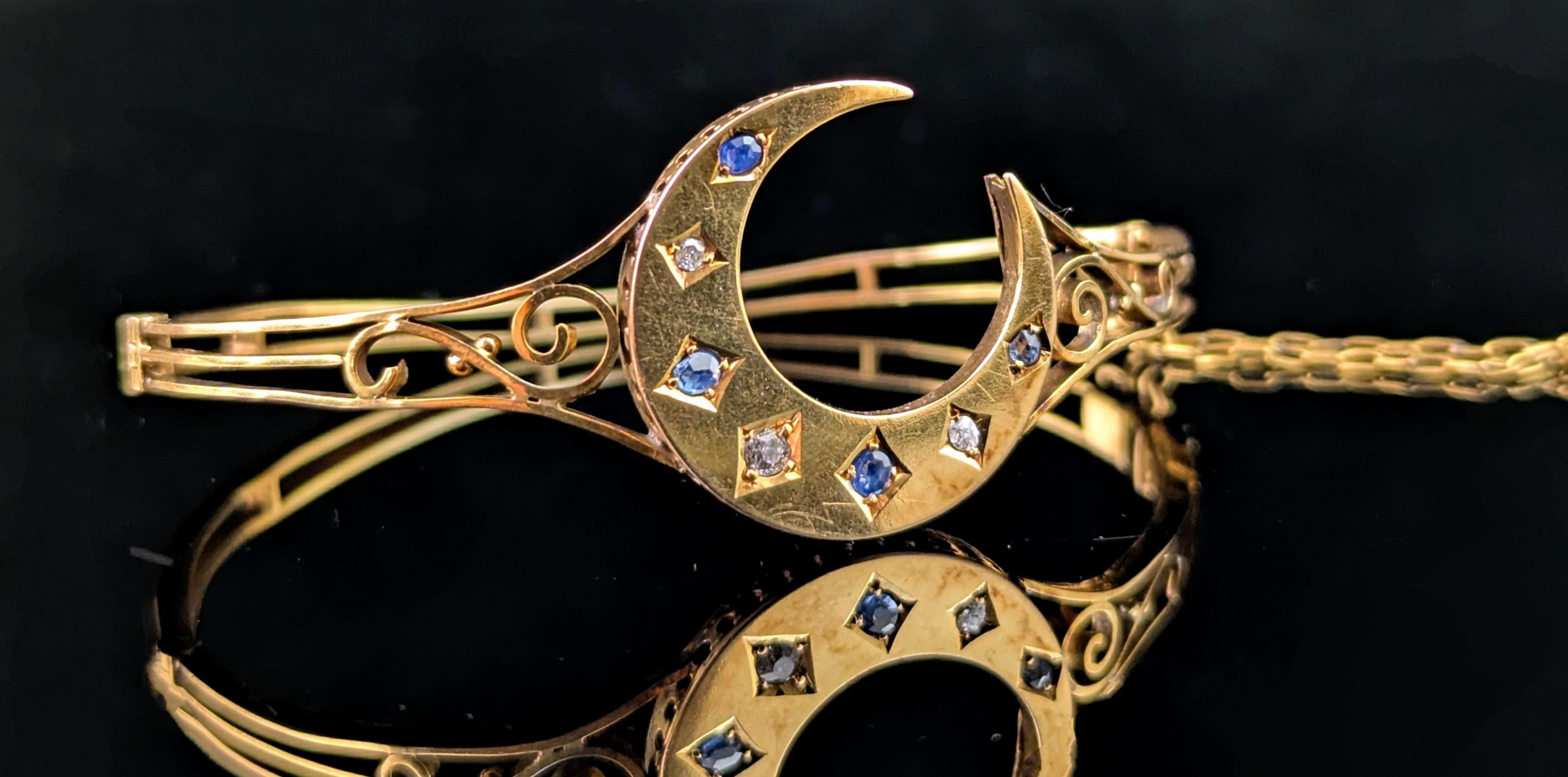 A gorgeous antique Victorian era Sapphire and Diamond bangle in 9ct yellow gold.

A pretty openwork style gold bangle with a hinged side clasp.

All eyes are on the main feature of the bangle though the wonderfully chunky crescent moon.

It is a