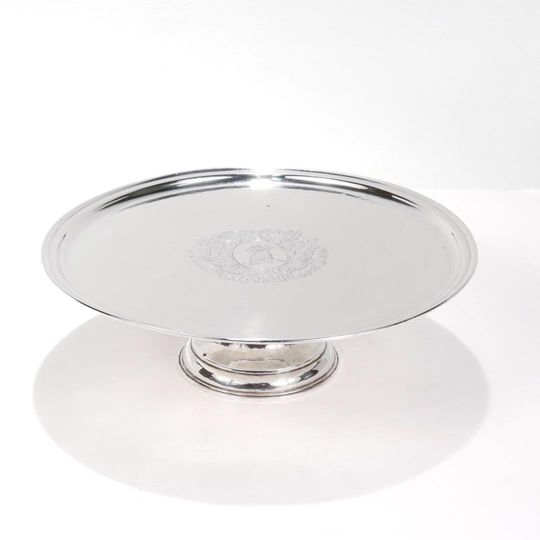 A fine antique silver tazza or cake stand.

In hand hammered sterling silver.

By Crichton Brothers (1890 - 1938).

Decorated to the center with with an engraved family crest or coat of arms with a ram to the center surrounded by floral devices,