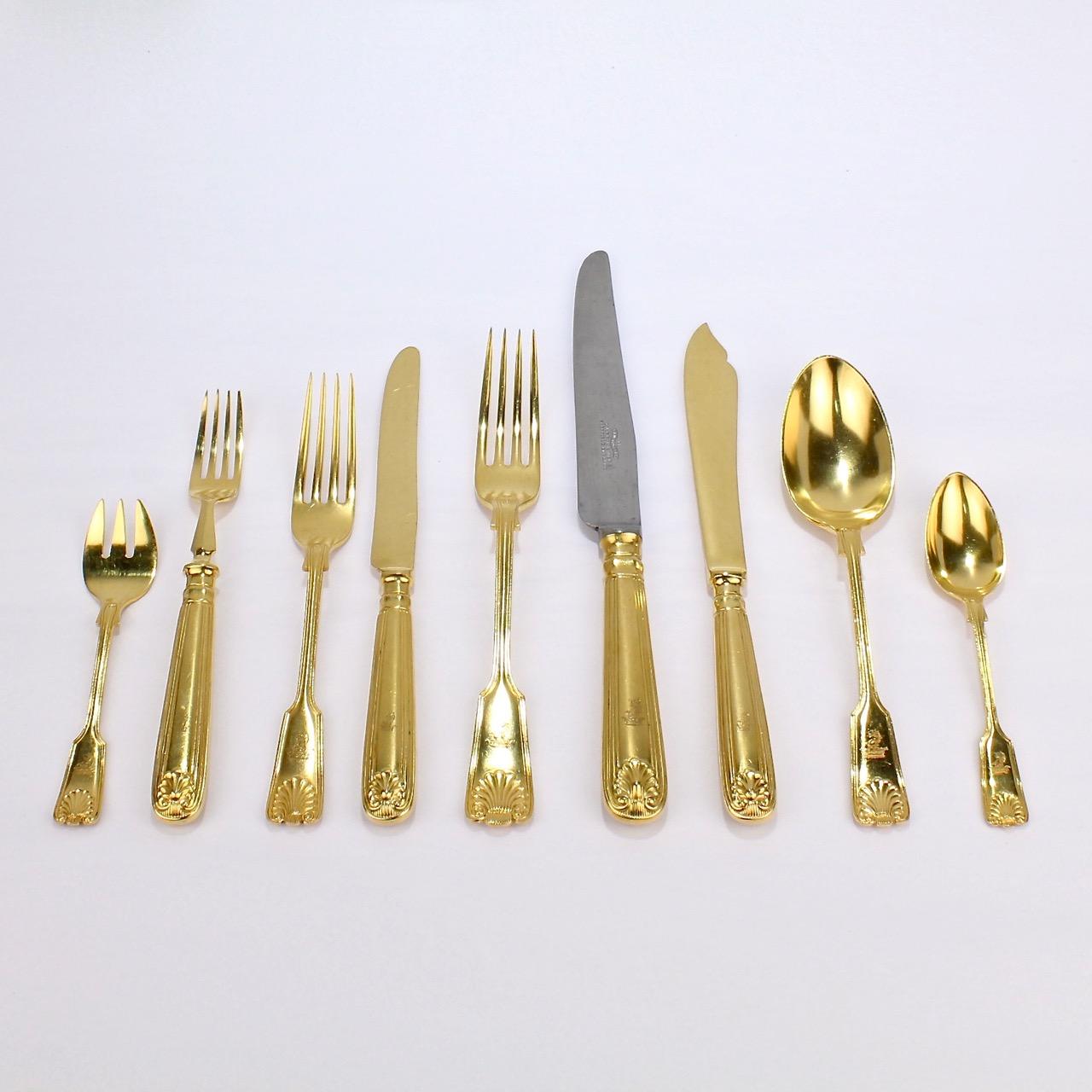 A very fine antique luncheon Mappin Plate flatware service by Mappin & Webb.

The pattern is a double fiddle-thread & shell variant. It is rare to find a set of their gold-plated flatware!

Each pieces bears an engraved family crest with a lion's