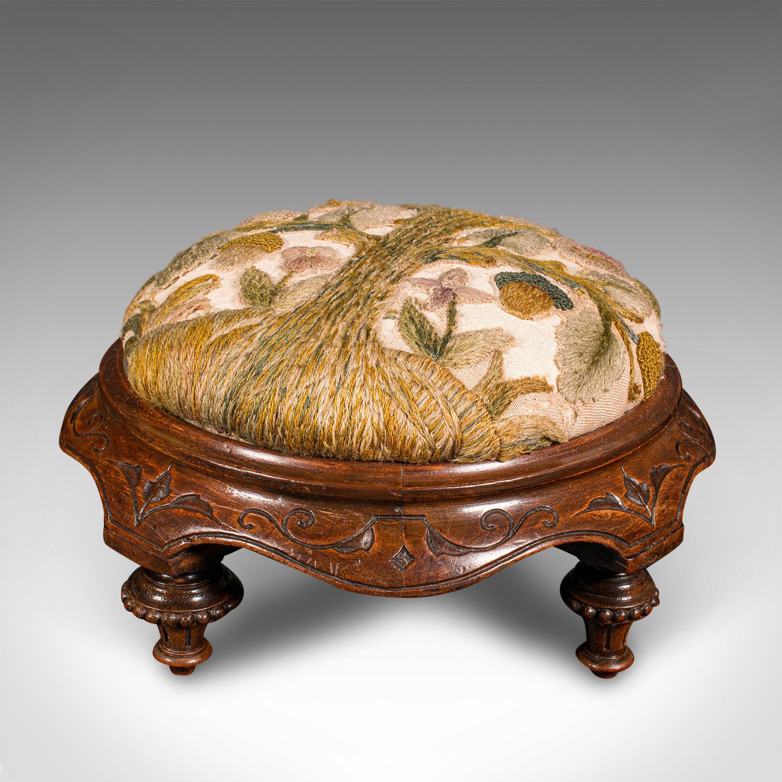 
This is an antique crewel work footstool. An English, walnut and embroidered textile stool, dating to the late Victorian period, circa 1880.

Charming stool, with eye-catching crewel work decor
Displays a desirable aged patina and in good