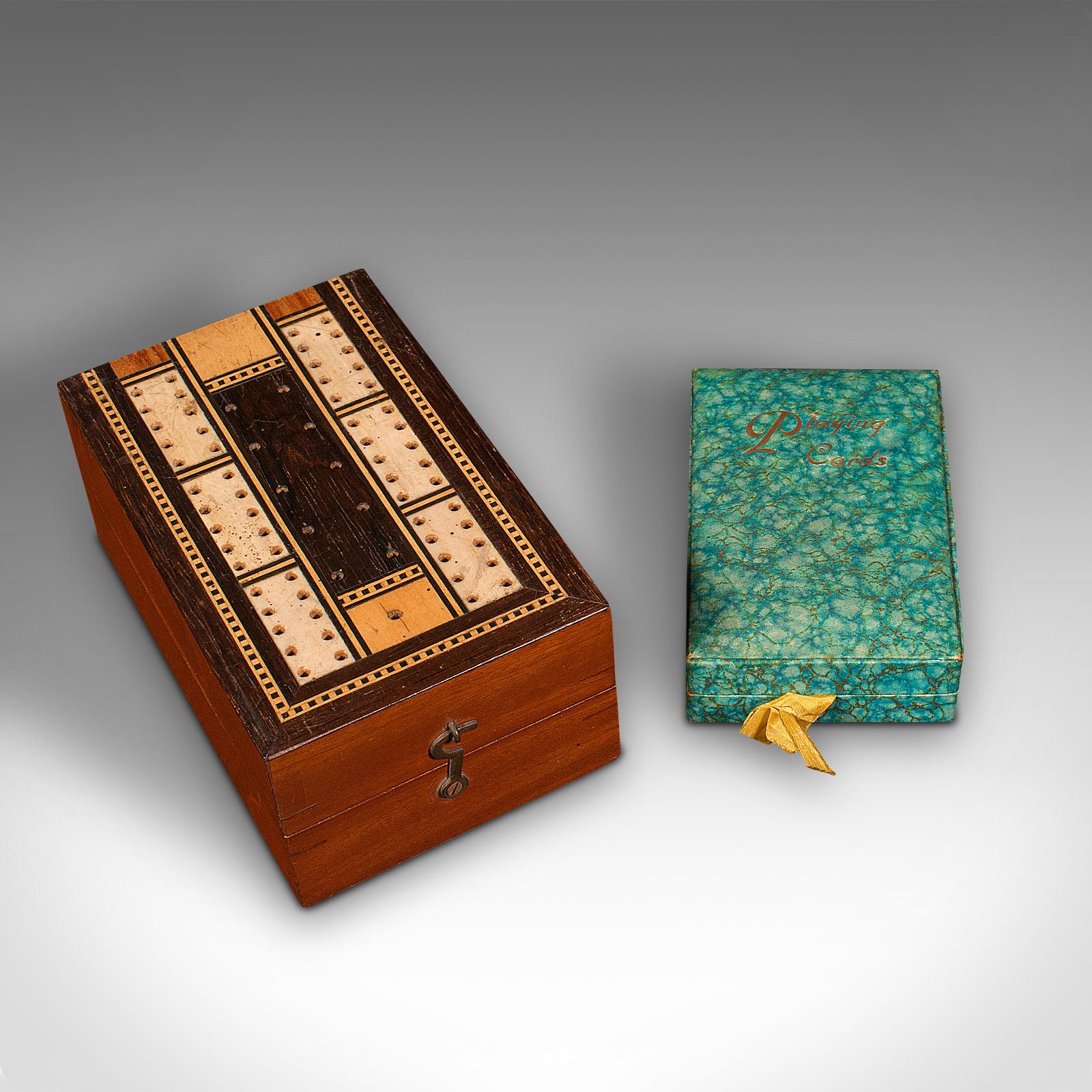 This is an antique cribbage game case. An English, mahogany and boxwood portable gaming box with playing cards, dating to the Edwardian period and later, circa 1910.

Delightful carry case for the impromptu card game
Displays a desirable aged