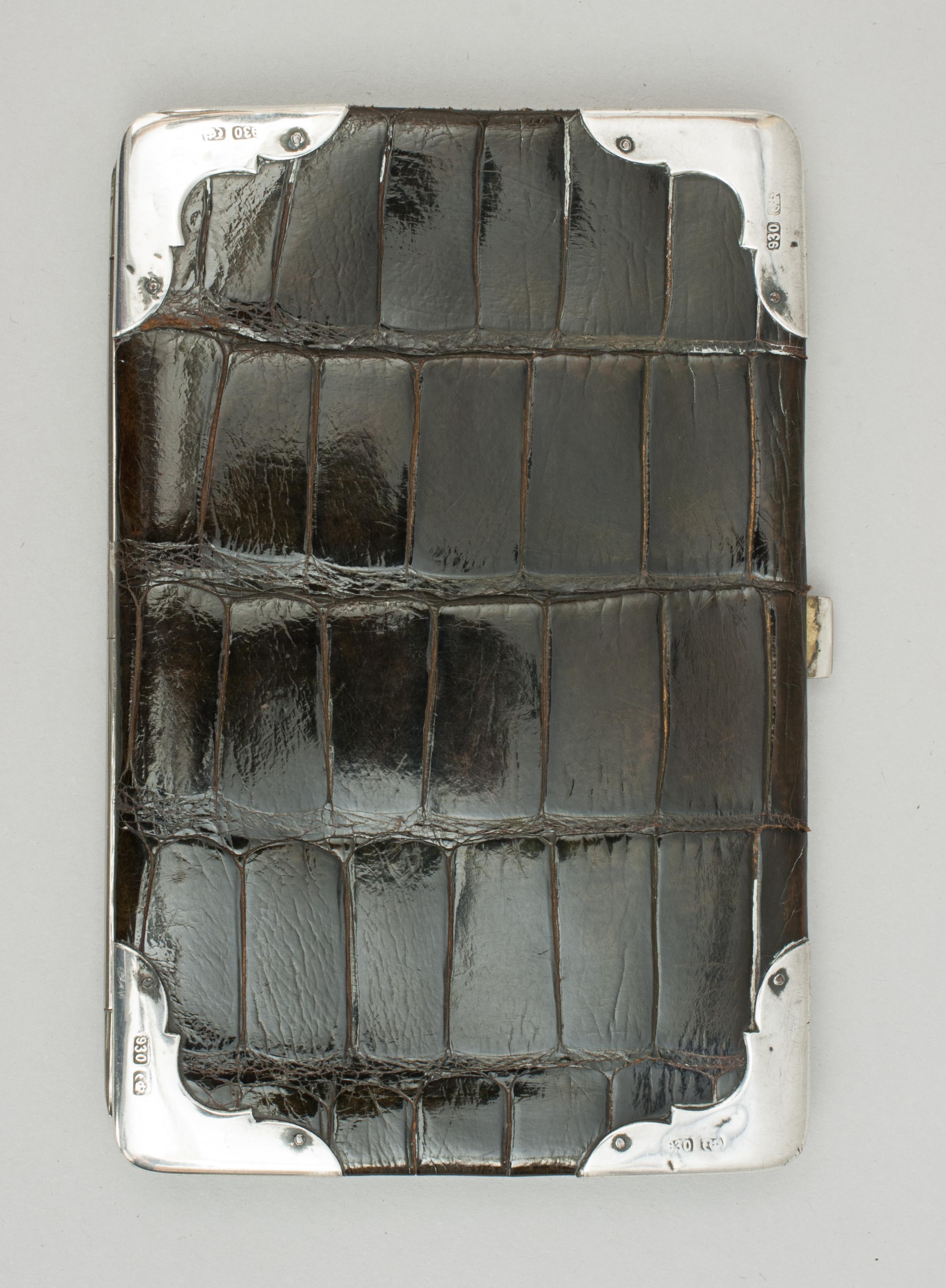 Leather crocodile wallet.
A well made continental crocodile wallet, purse, with a polished crocodile skin exterior with silver frame and fittings. It has silver hallmarked corners and the interior lined with soft leather having pockets and