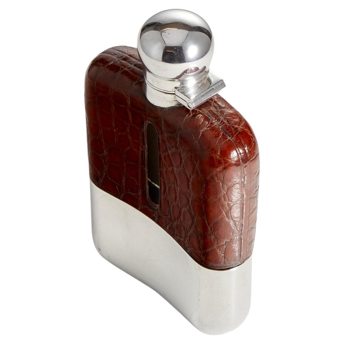 Antique Crocodile & Sterling Silver mounted Hip Flask by maker J Dixon & son
Sheffield 1913-14, Origin England.

This Flask is is in excellent condition and shows no obvious sign of wear. The glass is a perfect curved design to fit inside a