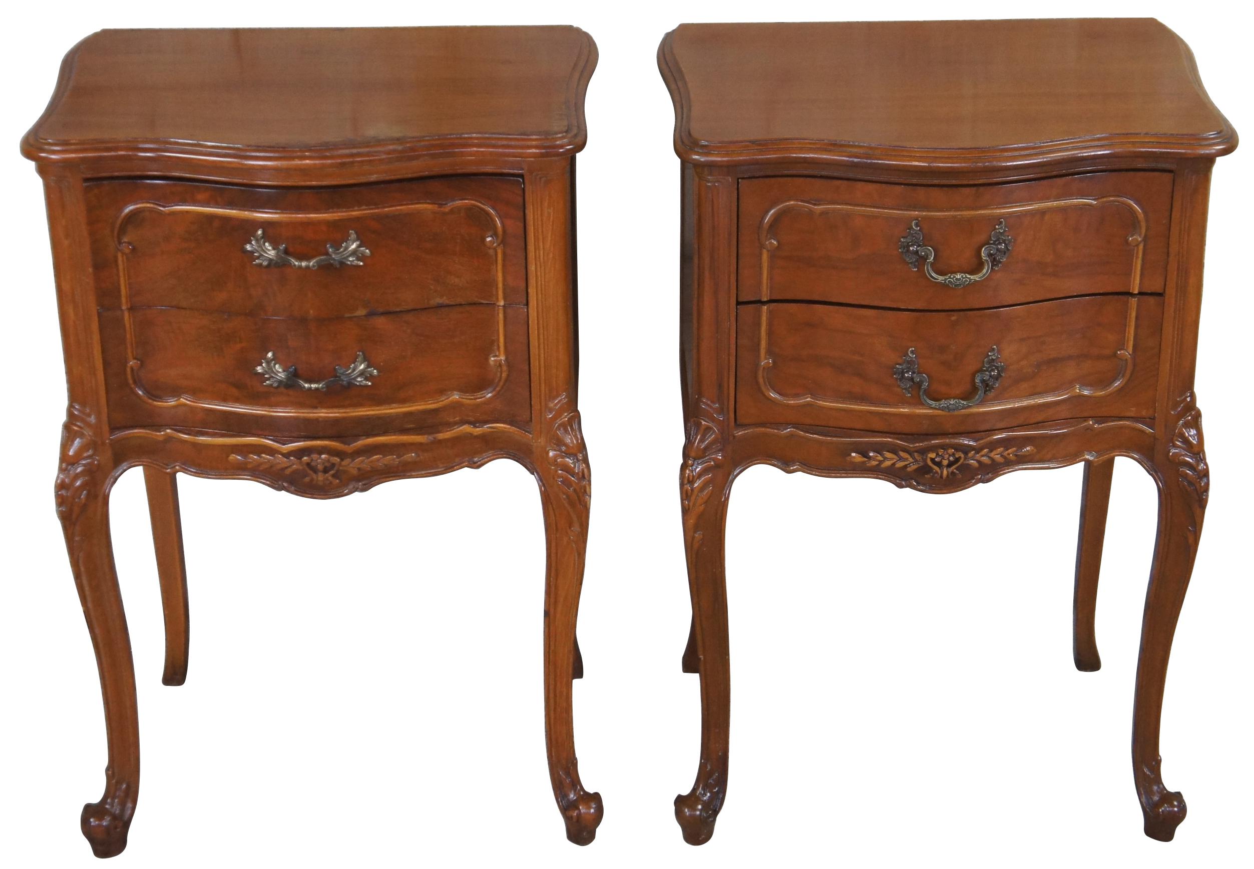 Circa 1940s French nightstands or end tables. Made from walnut with a serpentine front and crotch veneered drawers. Features carved accents, scalloped brass hardware, cabriole legs and glass tops.
  