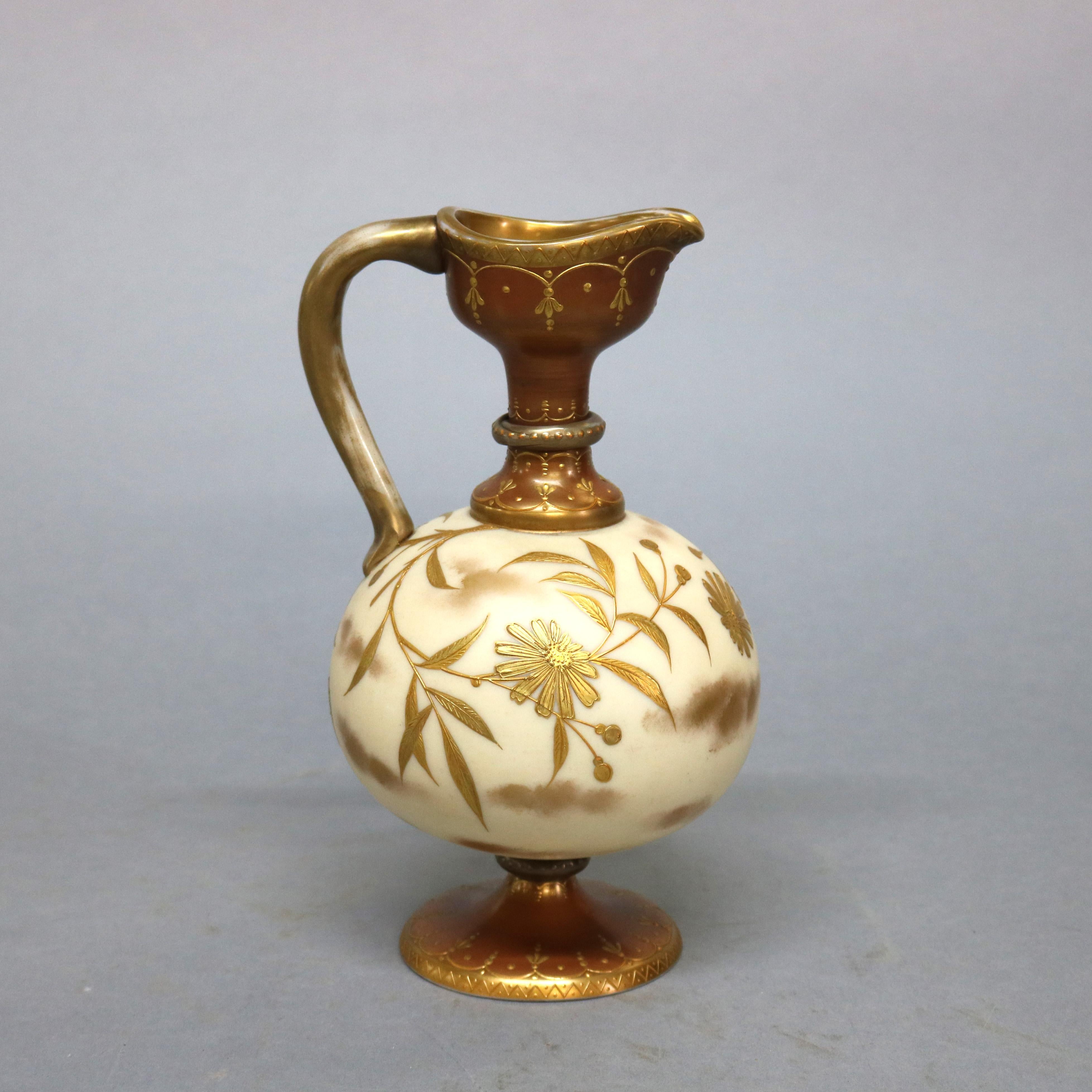An antique Crown Milano Mt. Washington Glass ewer offers bulbous footed vessel with foliate and floral gilt decoration throughout, numbered on base as photographed, circa 1890

Measures: 10.25