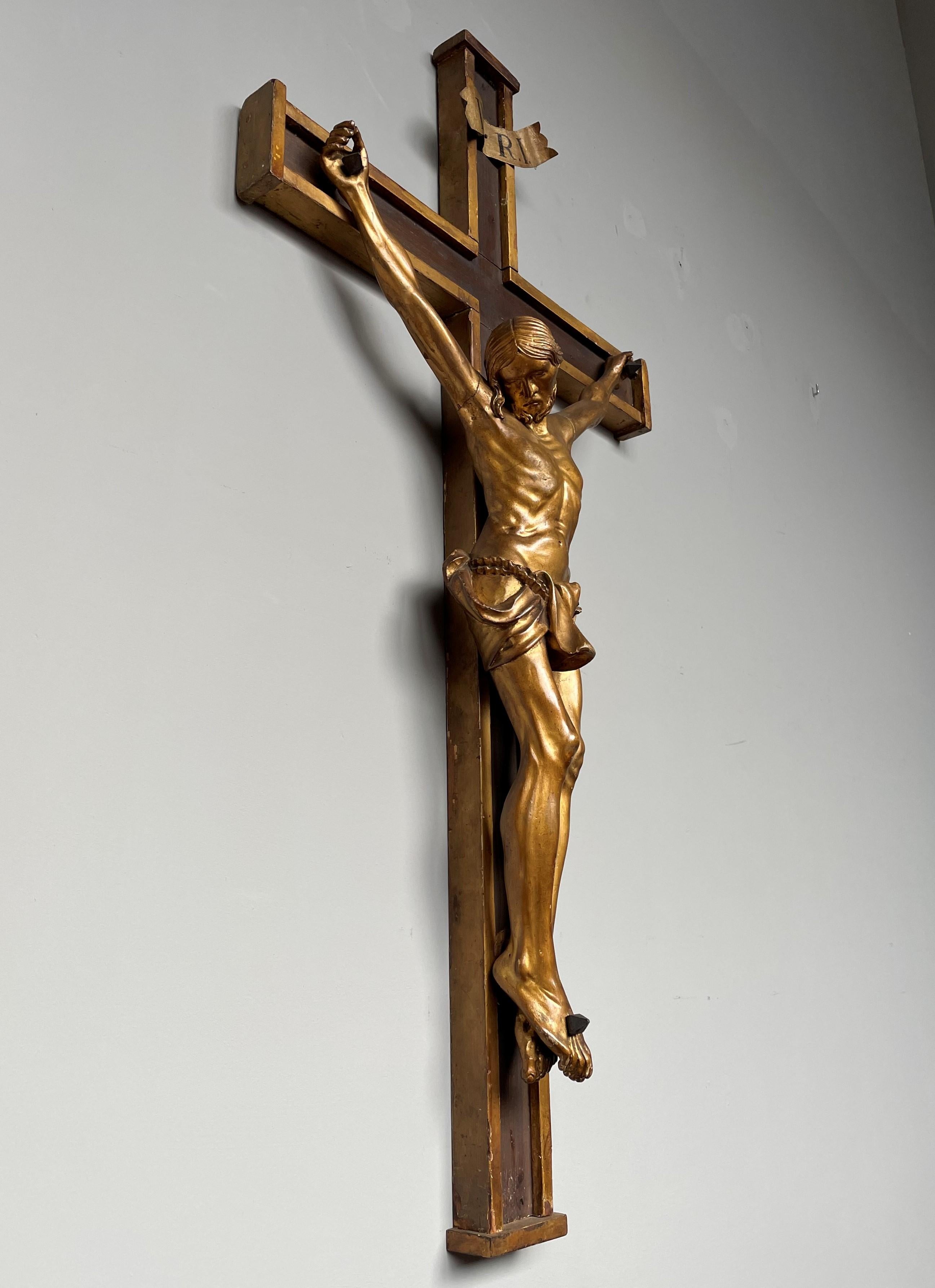 Large and impressive hand-crafted church crucifix.

This beautifully handcrafted crucifix for wall mounting comes with a top quality carved wooden corpus of Christ and especially for its age the gilding is in amazing condition. Both the quality of